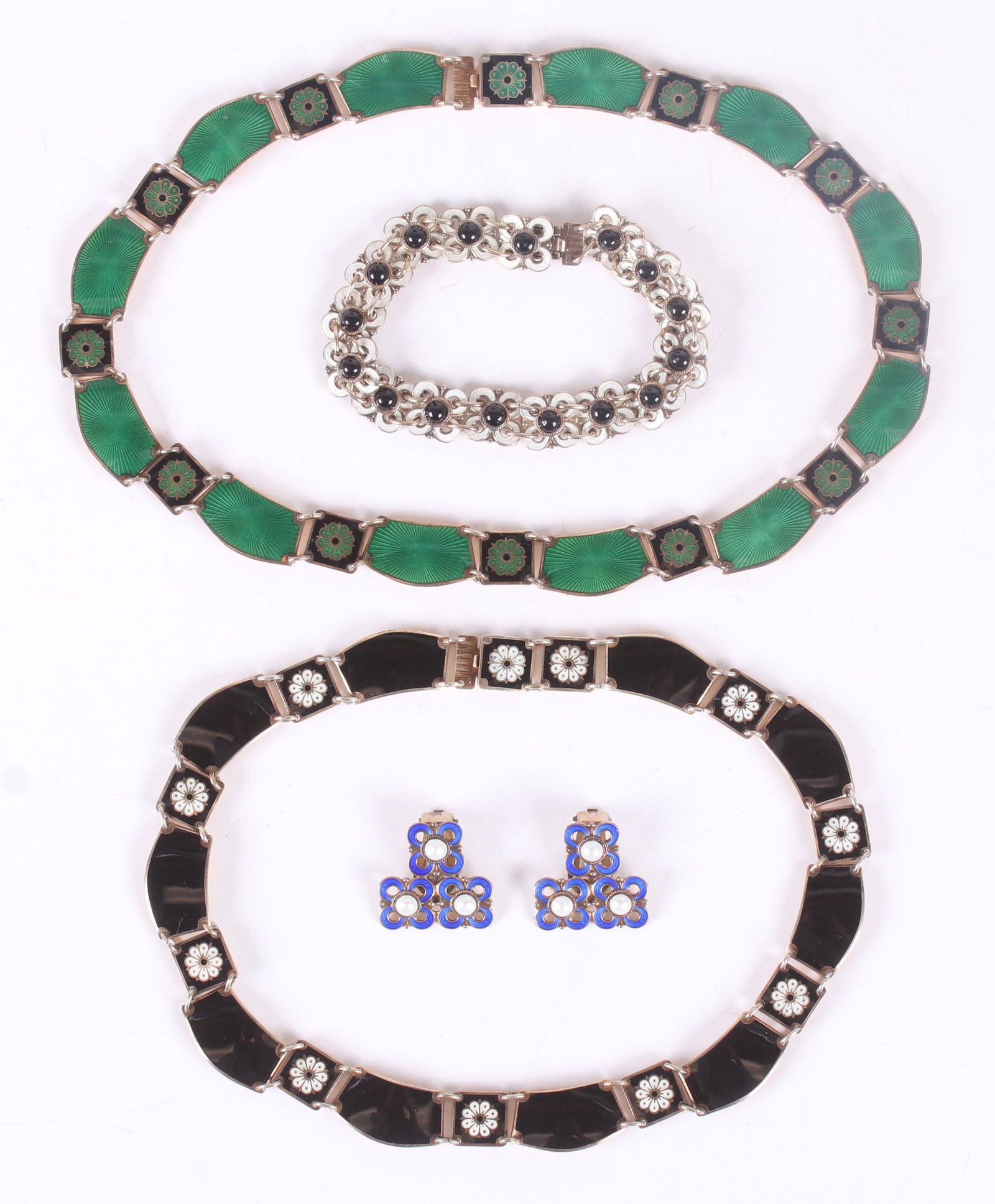 David Andersen Sterling Enamel Jewelry Lot: A black and white bracelet with floral links, a pair of blue and white floral earrings, a green and black necklace with floral decoration, and a matching black and white necklace. All signed. Dimensio