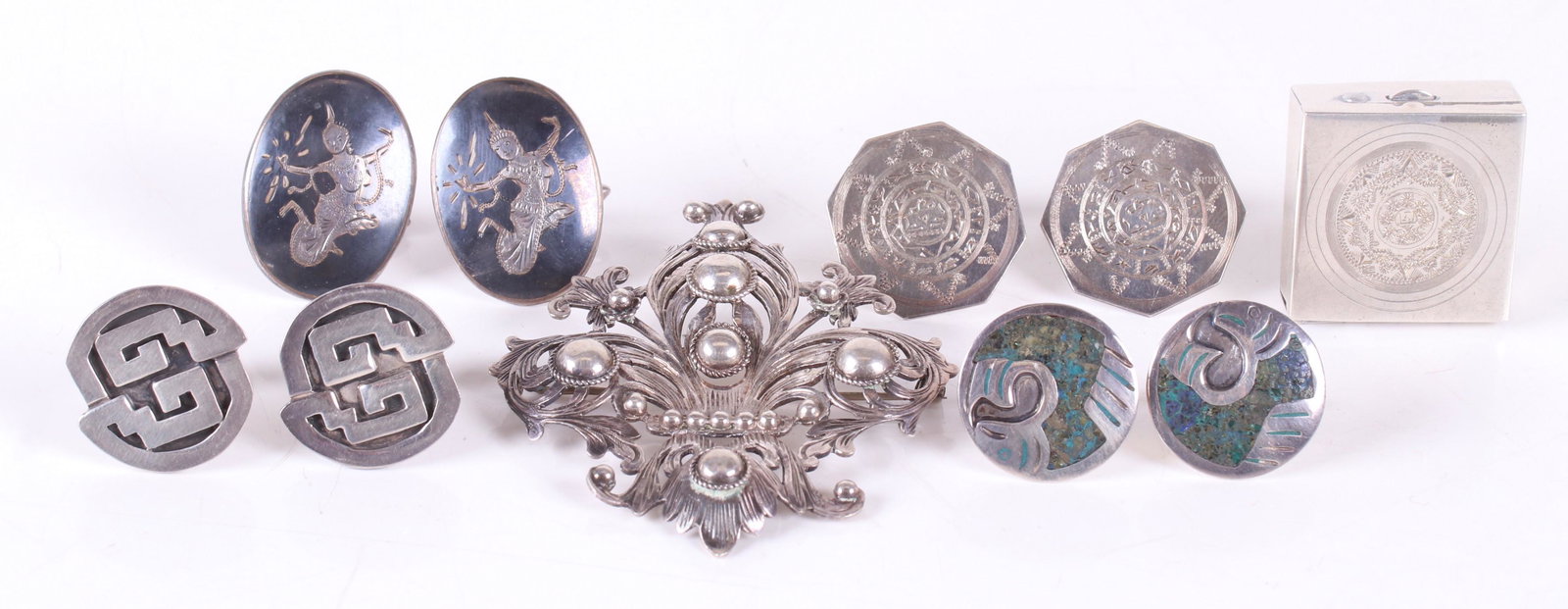 A Group of Sterling Silver Estate Jewelry: Comprising: a large brooch signed "Peruzzi", three pairs of Mexican cufflinks, a pair of cufflinks marked for Siam, and a Mexican pill box. Dimensions:From 1" in diameter to 3" x 2 1/2",the total appr