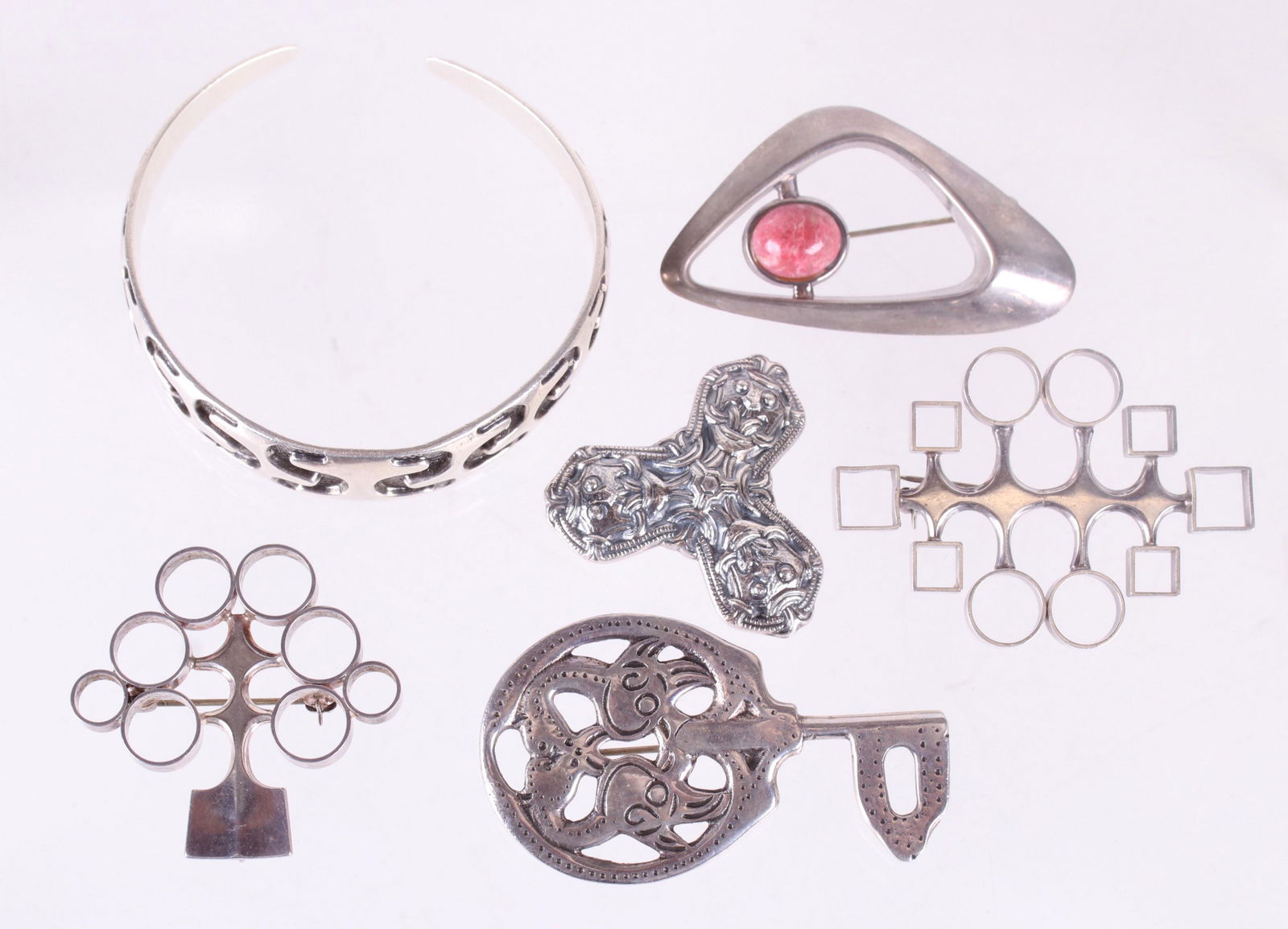 Group of David Andersen Sterling Silver Jewelry: Comprising: a heavy cuff bracelet, two modernist pins, a modernist pendant, and two reproduction Viking pins. Dimensions:From 1 1/2" x 1 1/2" to 2 1/2" x 2 1/2". The total approximate gross weight is