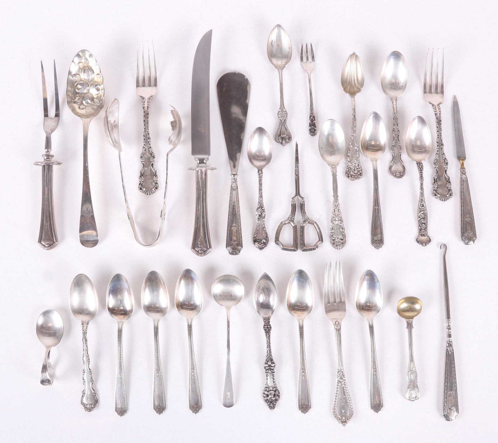 A Group of Estate Sterling Flatware: twenty-nine pieces including a four piece dressing set (shoe hook, shoe horn, nail file and scissors). Of special note is a Georgian berry spoon (with Victorian era decorated bowl) and a pair of ice t