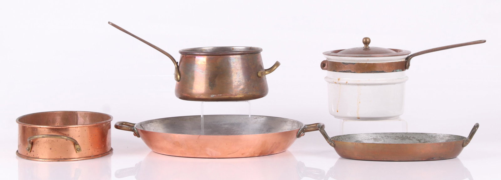 A Group of Copper Cookware: An unmarked sleeve with handles, a double boiler with porcelain pot, a French oval pan marked for the design store and a large circular French pan. Dimensions:From 7" to 13 1/2" in diameter, the heigh