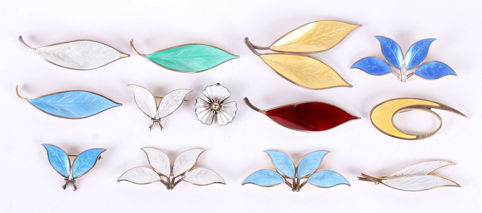 A Group of David Andersen Sterling Jewelry: All enameled, there are eleven foilate pins, an abstract pin in yellow enamel and a single white floral earring. Dimensions: From 1" x 1" to 2 3/4" x 1 3/4", the total approximate gross weight is 3.3