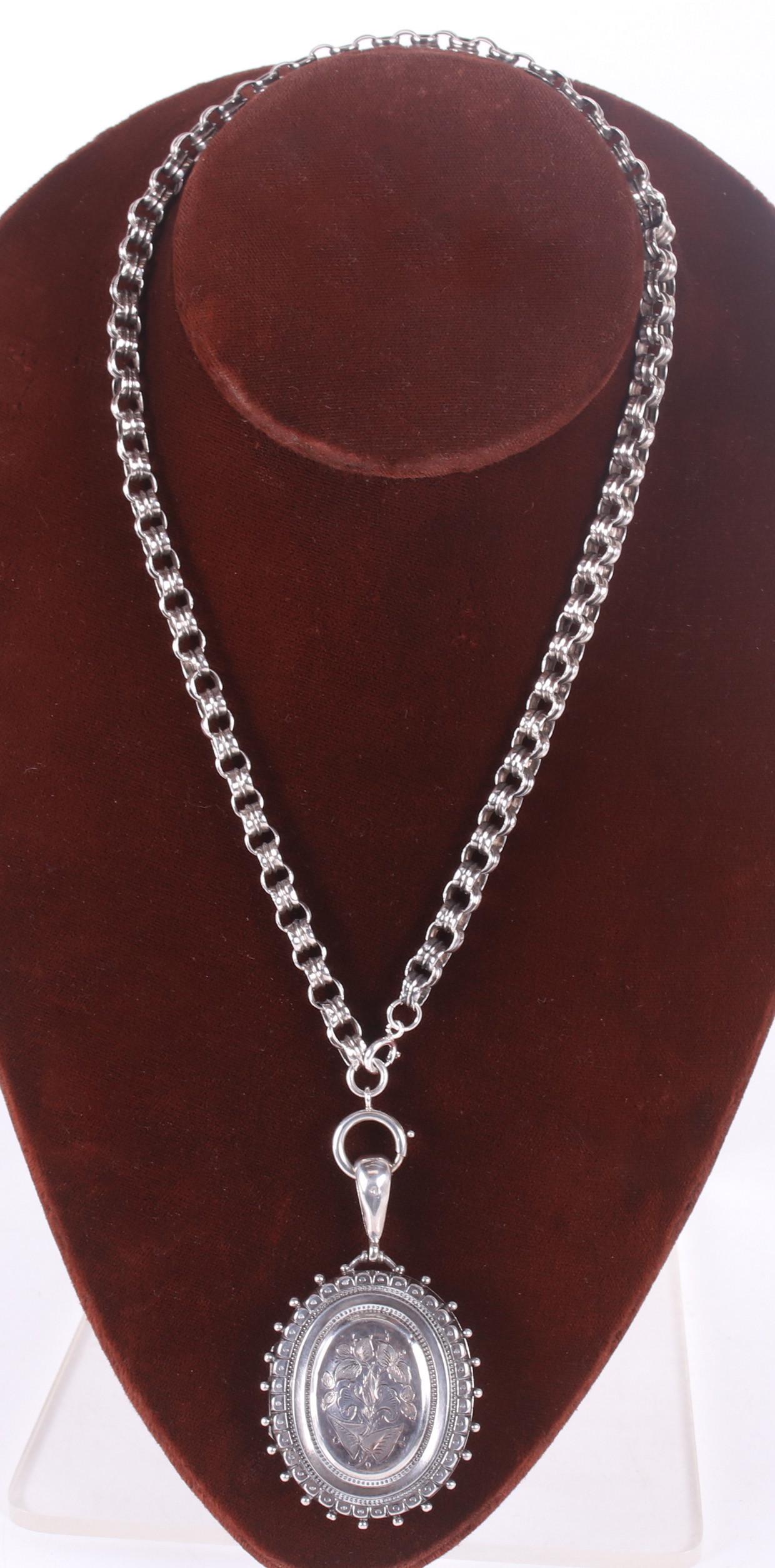 A Sterling Locket and Chain, Birmingham, 1884: A sterling locket with heavy chain, hallmarked for Birmingham, the year 1884 and the maker J & F.S. Dimensions: The locket is 2" x 1 /2", the chain is 18" long. The total approximate weight is 1.1 tro