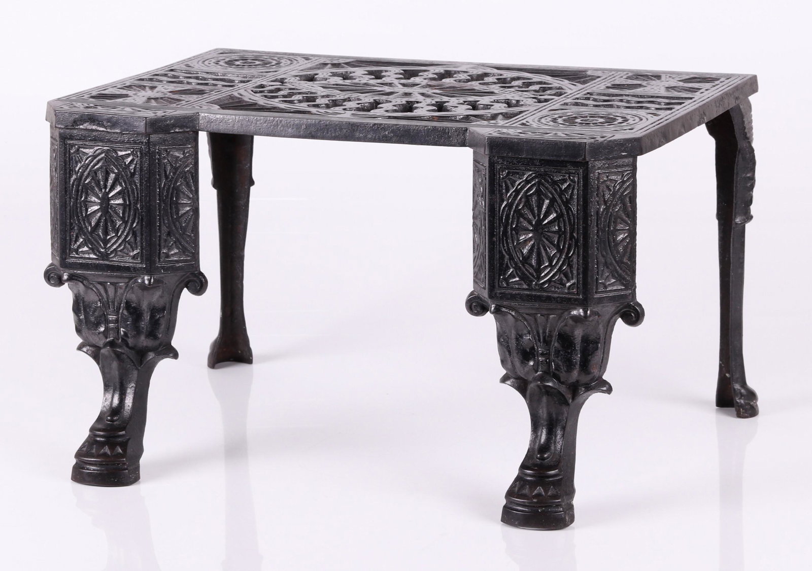 An English Cast Iron Footman circa 1860: With stylized paw feet, geometric and classical design elements. The English Registry number 146537 is located at the back of each front leg Dimensions: 20" x 14", 12" tall.