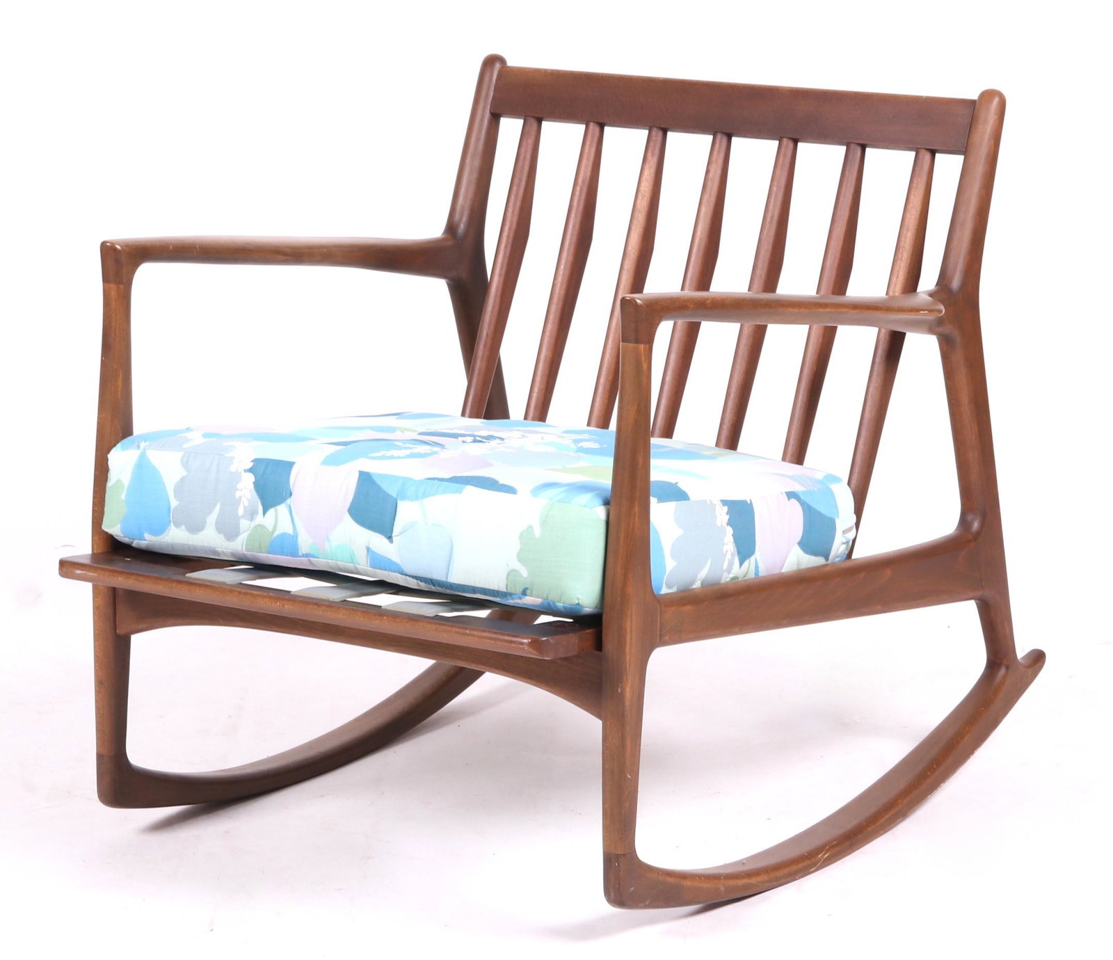 A Teak Rocking Chair: Scandinavian, with seven vertical slats at the back. The cushion is a replacement. Rubber support straps labeled "J.M. Birking & Co Copenhagen". Dimensions: 30" x 39", 28" tall. Provenance: From a loc