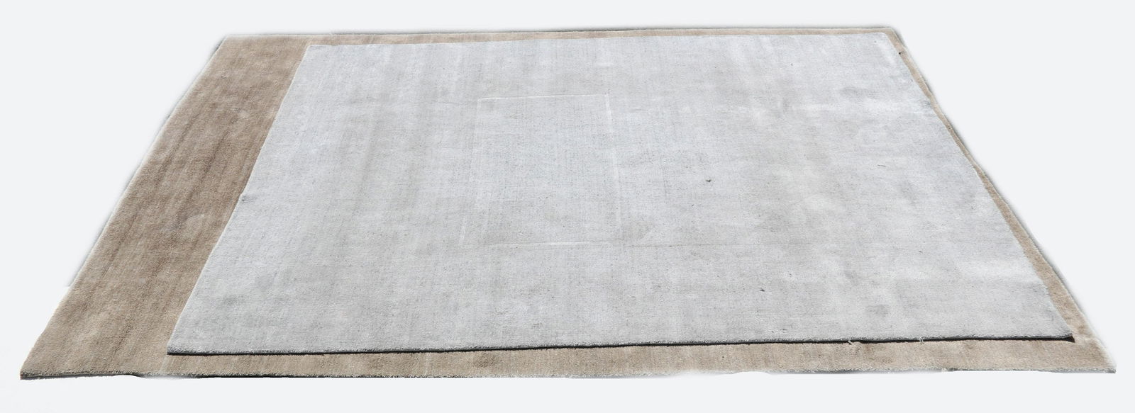 Two Rugs by Bob Williams and Mitchell Gold: Two "Shimmer" rugs, one in the mink color and another in quartz. Dimensions: 106" x 140" and 119" x 96" Provenance: From a local collection.