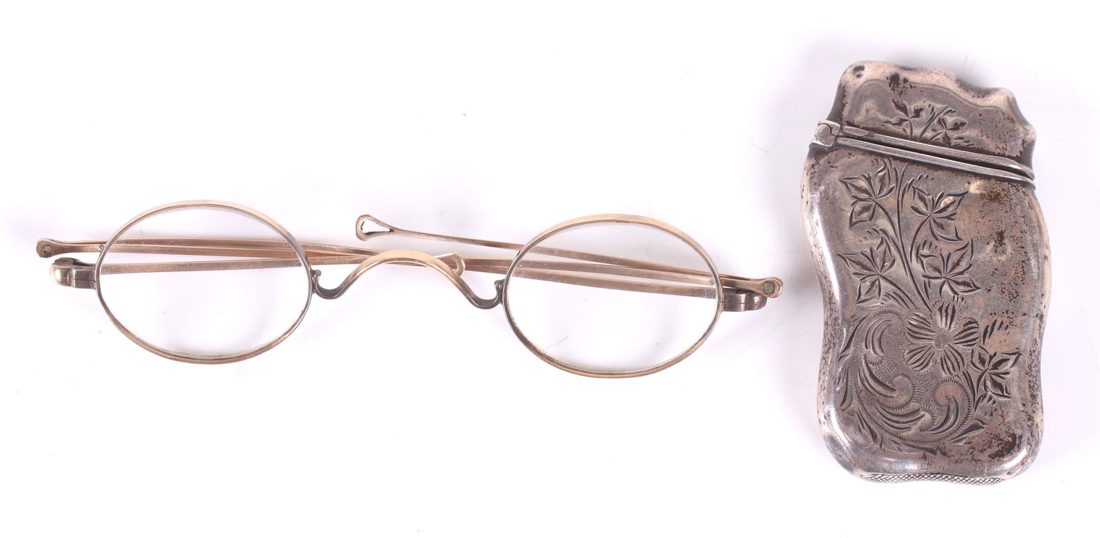 A Pair of 14k Gold Spectacles and a Match Safe: 19th century, unmarked but tested as 14k. With what appears to be the original case. Together with an Art Nouveau period sterling silver match safe by Whiting. Dimensions: The case is 5" x 1 1/2' x 1/