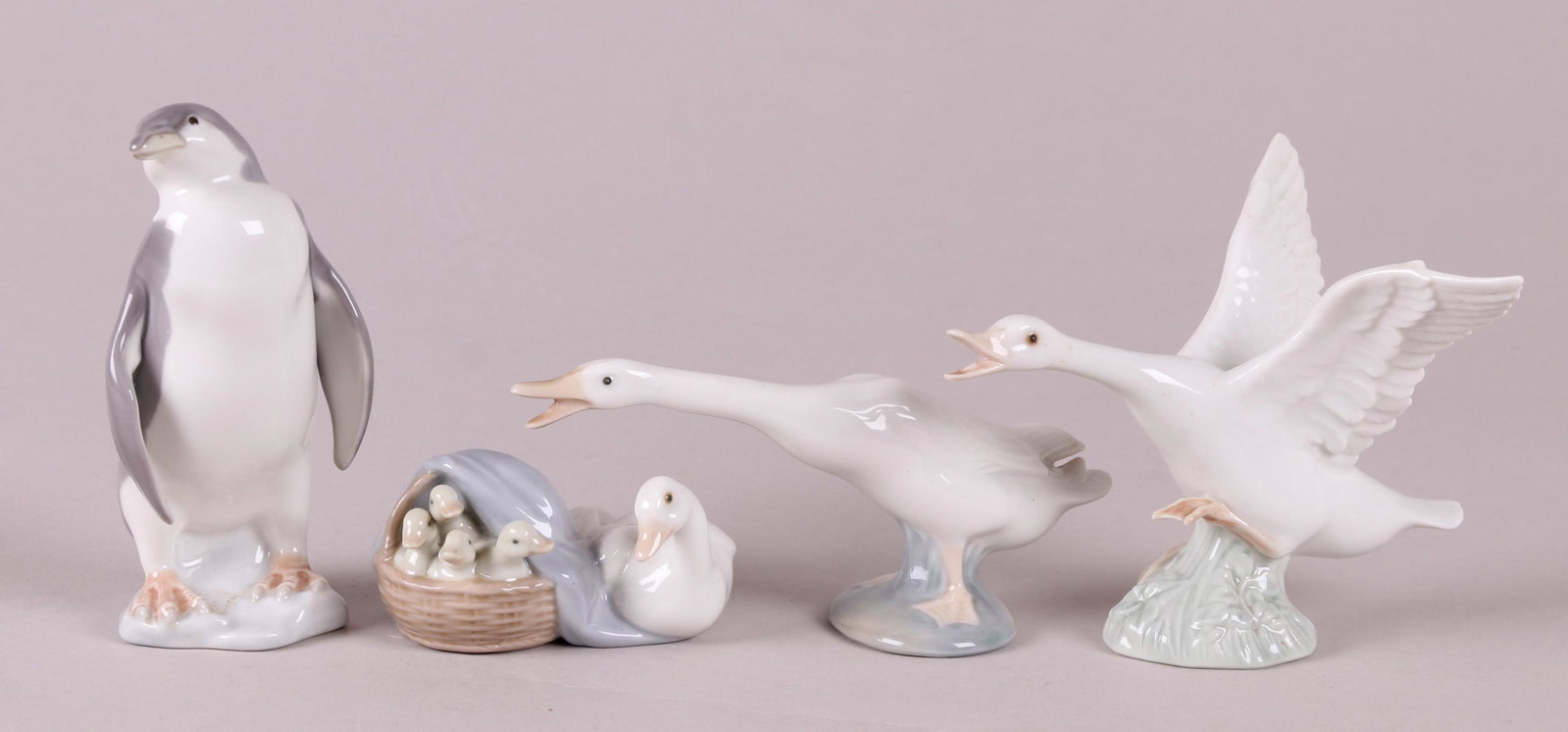 Four Lladro Animal Figures: "Penguin", "Ducklings", "Duck jumping", and "Duck". Dimensions: From 2" to 5 1/2" tall.