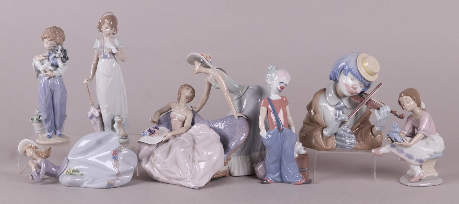 A Group of Lladro Figures: "The Blues", with original box, "Best friend" with original box, "Damita reclining" with original box, "Summer Stroll" with original box, "Destination Big Top", with original box, "Sick Doggie", no bo