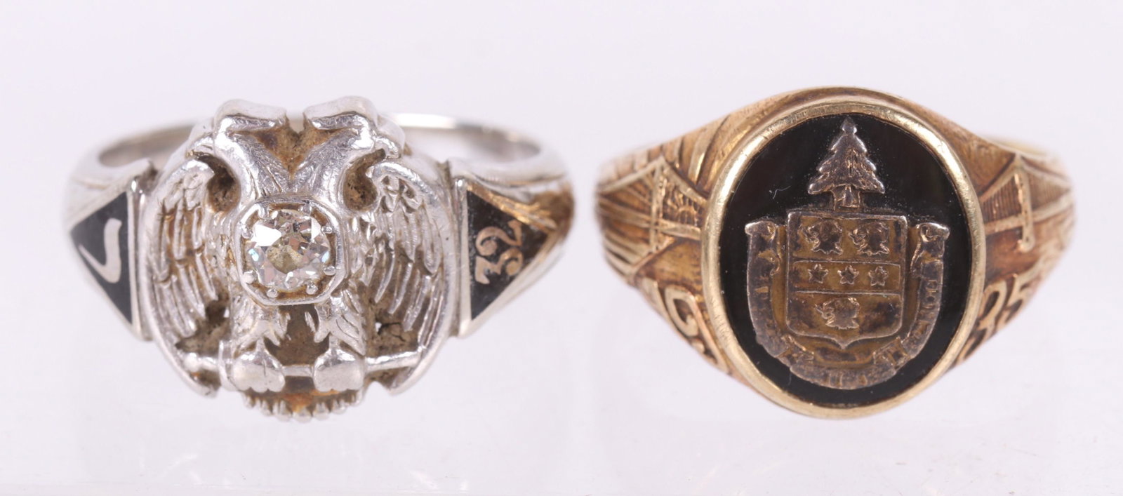 Two Gold Class Rings: A 14k white gold and platinum ring dated for 1932 and decorated with a double headed eagle and central diamond and a 10k yellow gold example dated for 1935. Dimensions: The 14k gold ring has an approx
