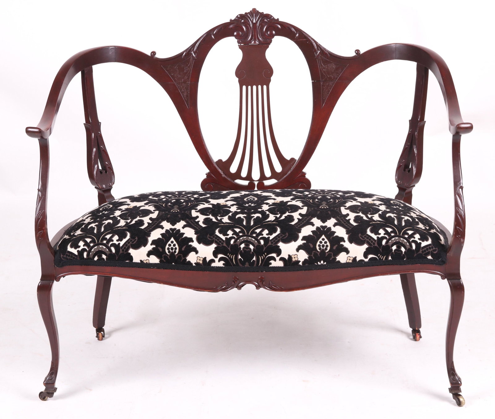 An Edwardian Style Loveseat: Mahogany, with floral black and white modern upholstery. Dimensions: 41 1/2" from arm to arm, 18 1/2" deep, 17" seat height and 35" tall overall.