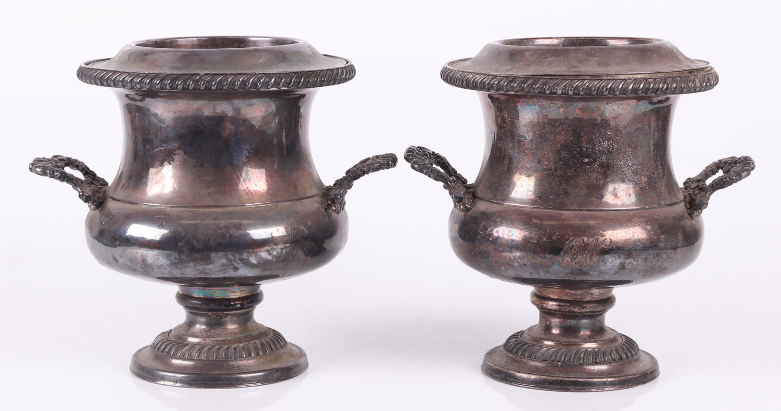 A Pair of English Silver Plated Wine Coolers: 19th century, each with Rococo style handles and gadrooning. Dimensions: Each is 10" handle to handle and 10" tall.