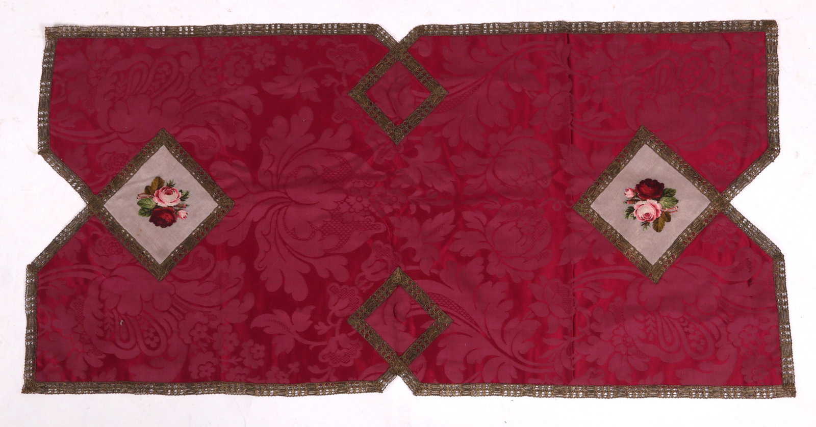 A Needlework and Silk Table Cover: 19th century, with metallic thread at the edges, floral and foliate decoration. Dimensions: 49" x 24".