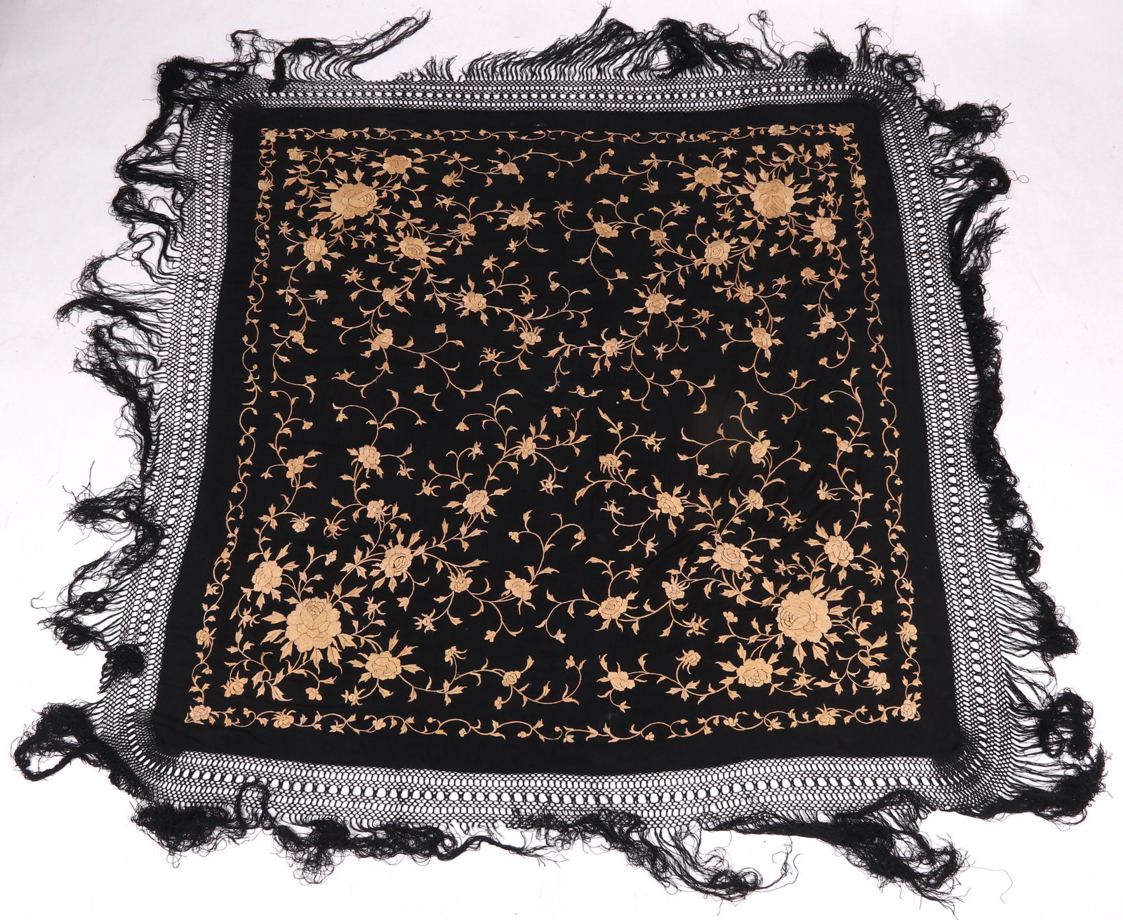 A Chinese Export Silk Piano Shawl: 19th century, black with hand stitched prunus blossom decoration. Dimensions: 59" x 55" not including the fringe.