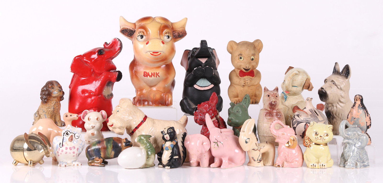 A Collection of Toy Banks, Various Animals: A large group of vintage banks, various animals including dogs, elephants, bears, etc... Materials include pottery, plaster, wood and metal. Dimensions: From 3" to 9 " tall. Provenance: From a New Jer