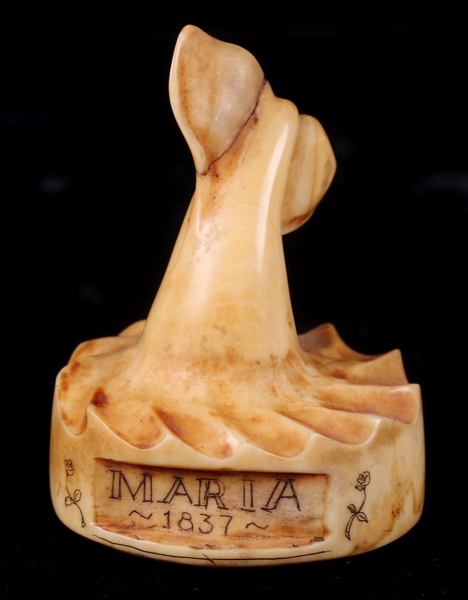 A Scrimshaw Whaling Log Stamp: Dated for 1837, for a ship named "Maria", with whale tail handle, whale and floral decoration. Dimensions: 1 1/4" in diameter, 1 3/4" tall.
