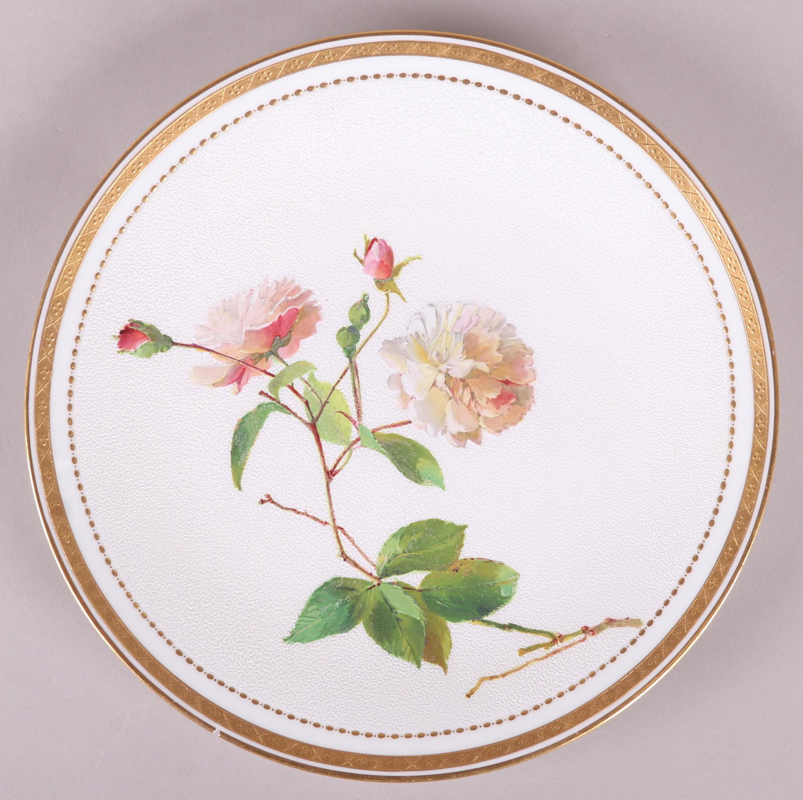 A Fine Minton Porcelain Plate: Late 19th century, with a white ground that features a coral pattern and enameled floral decoration, impressed mark. Dimensions: 9 1/2" in diameter. Provenance: From a local collection.
