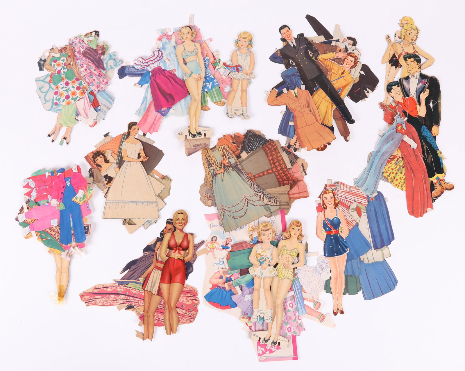 A Group of Vintage Paper Dolls: Subjects are: Lil' Abner, Peggy, Movie Stars, Polly, Patty, Red Cross Nurse, the Armed Services, and Little Women. Dimensions: Various. Provenance: From a local collection.