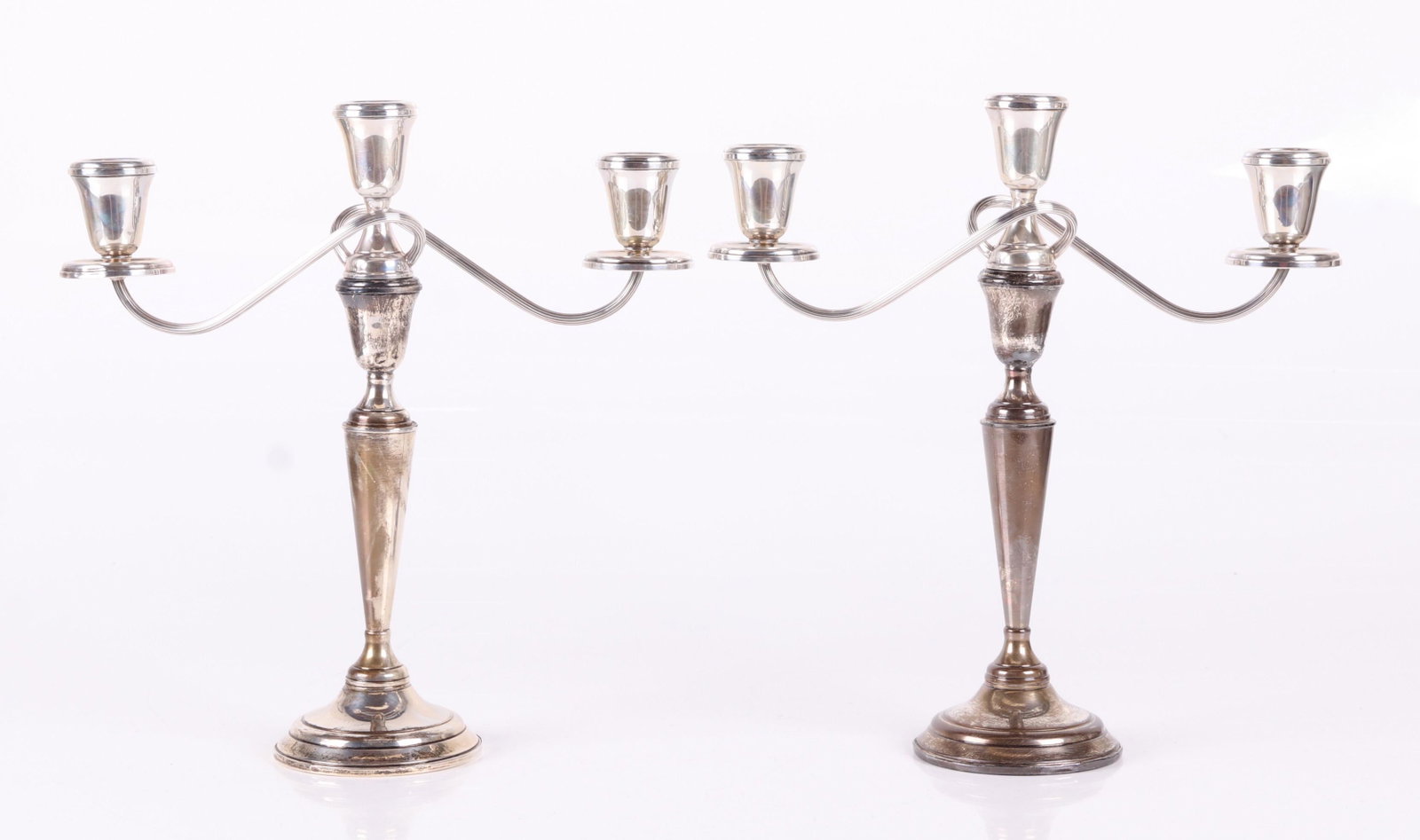 Sterling Candelabra, Garden Silversmiths: 20th century, each three light and in two parts, weighted. Marked as pictured. Dimensions: Each is 12" from arm to arm and 13" tall. Provenance: From a Delaware estate.