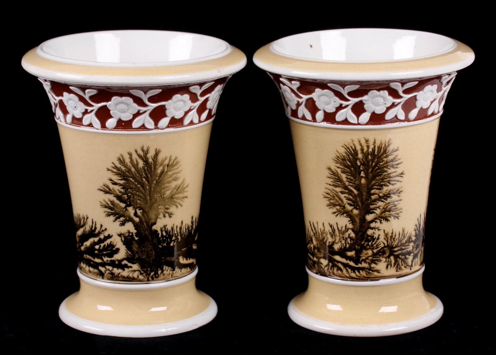 A Pair of Spode Mochaware Spill Vases: Early 19th century, each with a tan colored ground, seaweed decoration and a band of raised flowers on a reddish-brown ground. Impressed marks as pictured. Dimensions: Each is 3 1/2" in diameter and 4