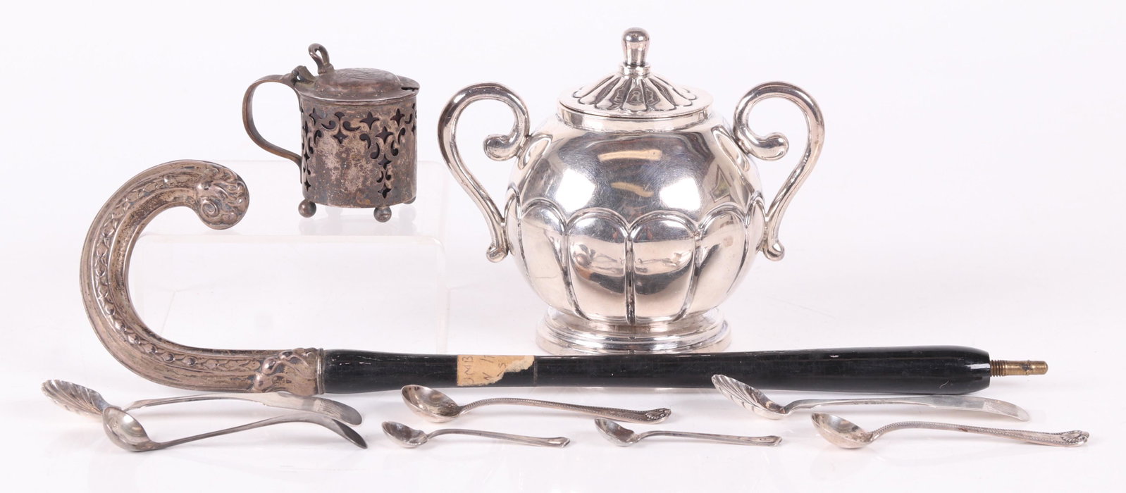 A Group of Sterling Silver Estate Items: Comprising: a heavy and lobed Mexican sterling covered sugar bowl marked for Vigueras, a wooden parasol handle with .800 silver terminal, a sterling mustard pot by Dominick and Haff with red glass lin