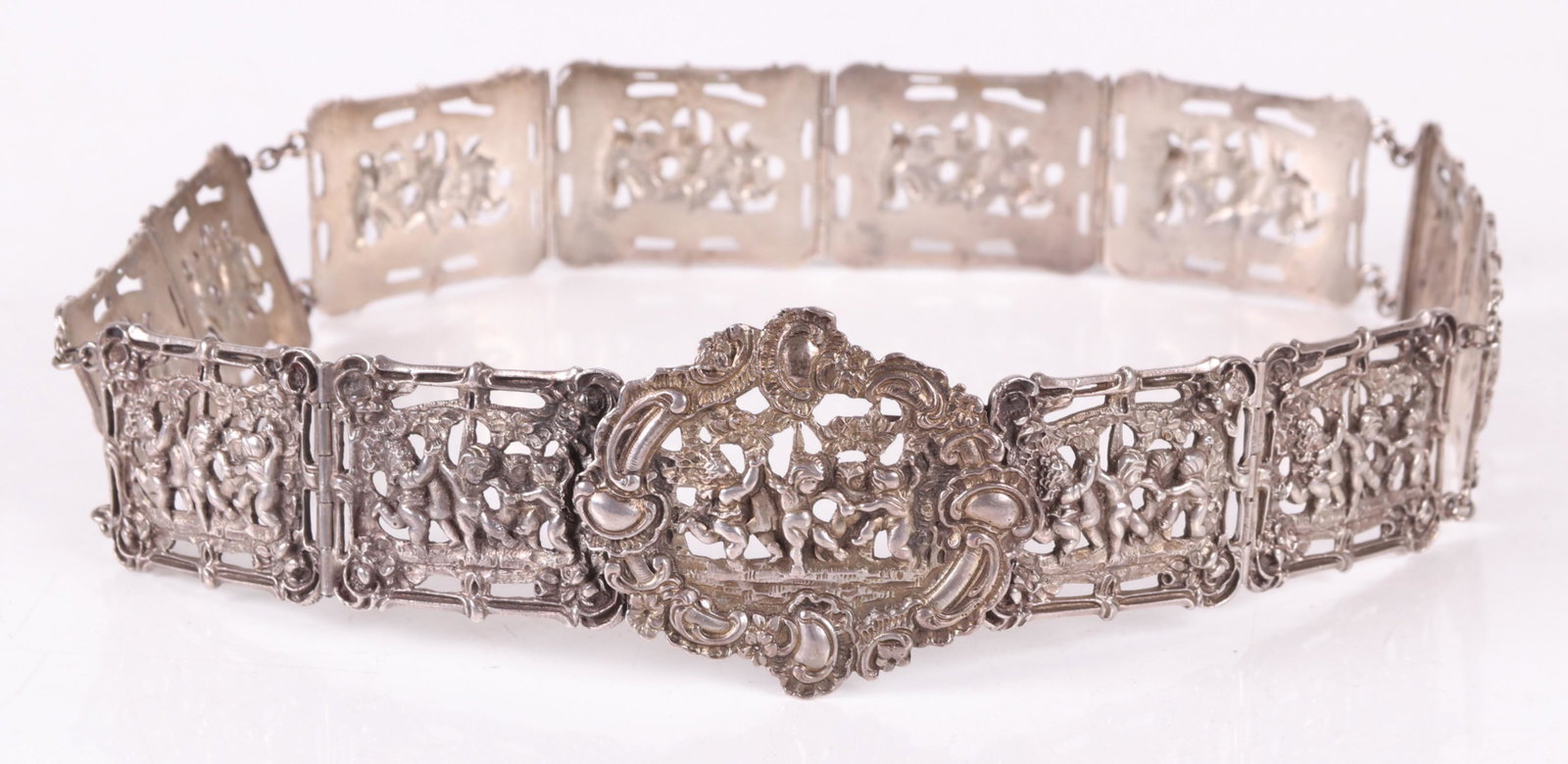 An .800 Silver Belt, Continental: Late 19th century, with buckle and twelve links, each cast with Rococo decoration that features putti. Marked for .800 silver, no maker's marks. Dimensions: Approximately 11 troy ounces. 28 1/2" x 2 1
