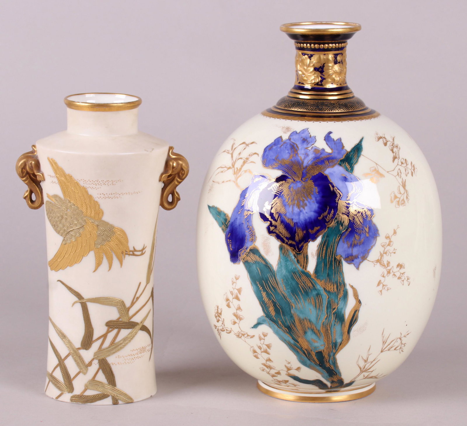 Porcelain, Royal Worcester, Royal Crown Derby: An egg form Royal Crown Derby vase with iris decoration and gilt elements and a vase by Royal Worcester with gilt elephant head handles and decoration which features a heron and dragonflies. Each mark