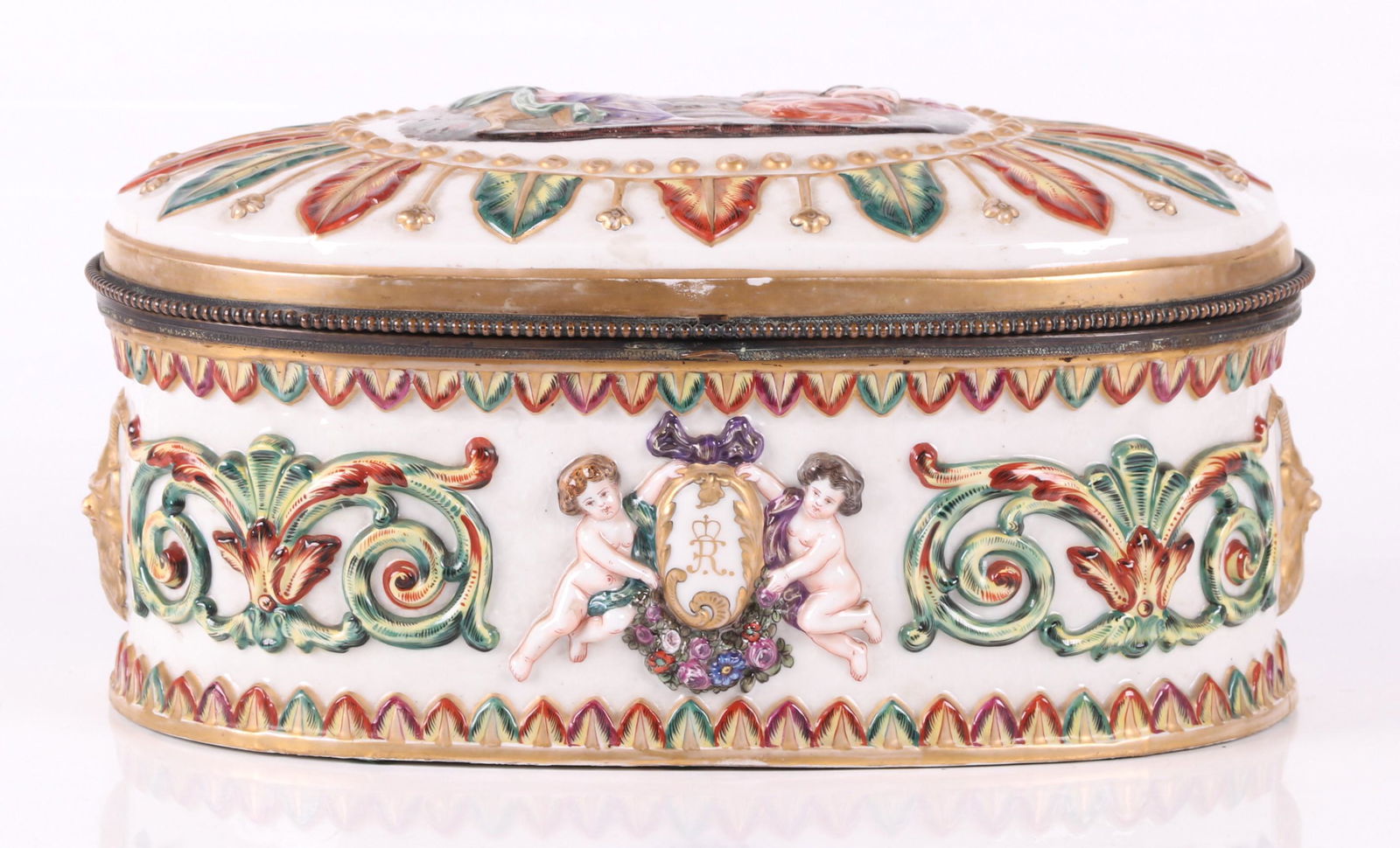 A Large Capodimonte Porcelain Casket: With typical polychrome raised figures, scrolled and foliate decoration. Underglaze blue mark as pictured. Dimensions:14" x 10", 7" tall. Provenance: