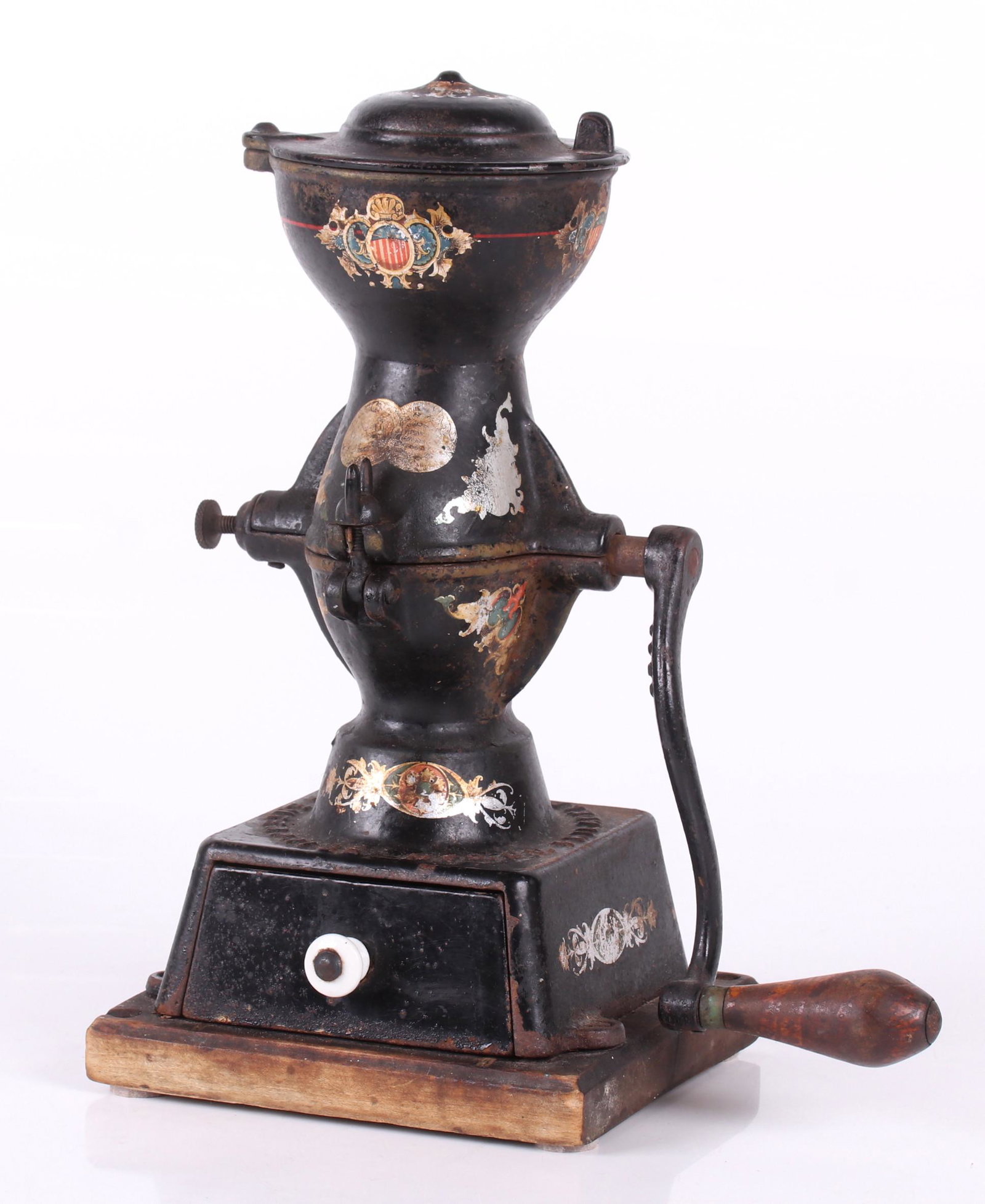 An Enterprise Coffee Grinder: Late 19th century, with original black paint and decal decoration. Mounted on a wooden base. Dimensions:10 1/2" x 6 1/2", the height is 13 1/2". Provenance:
