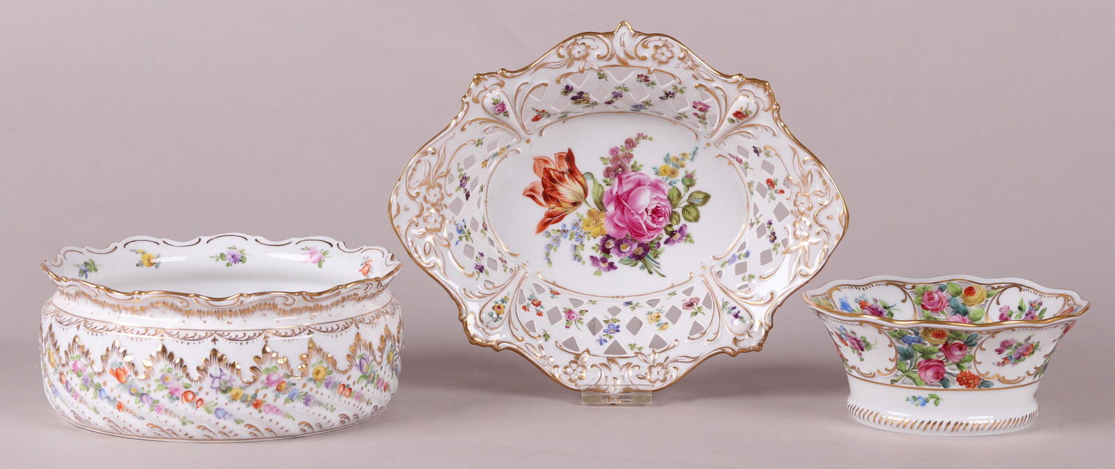 Three Pieces of Dresden Porcelain: A reticulated wine coaster, a bowl with a scalloped edge and a reticulated basket which is marked for Ambrosius Lamb. Dimensions:From 6 1/4" in diameter to 10 1/2" x 8 1/2", the heights range from 2 1