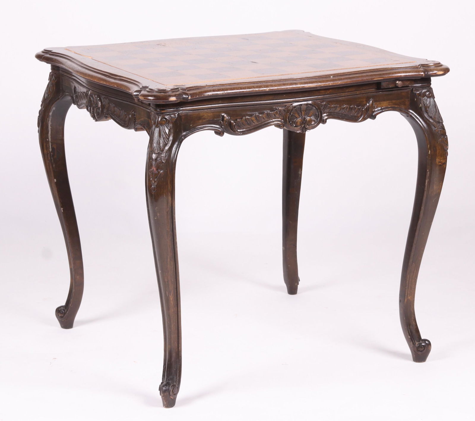 A French Provincial Style Games Table: 20th c. with a scrolled foot, cabriole legs, carving at the knees, and at each side, the top is reversible one side with green felt the other with chessboard, the table features a cup holder at each c