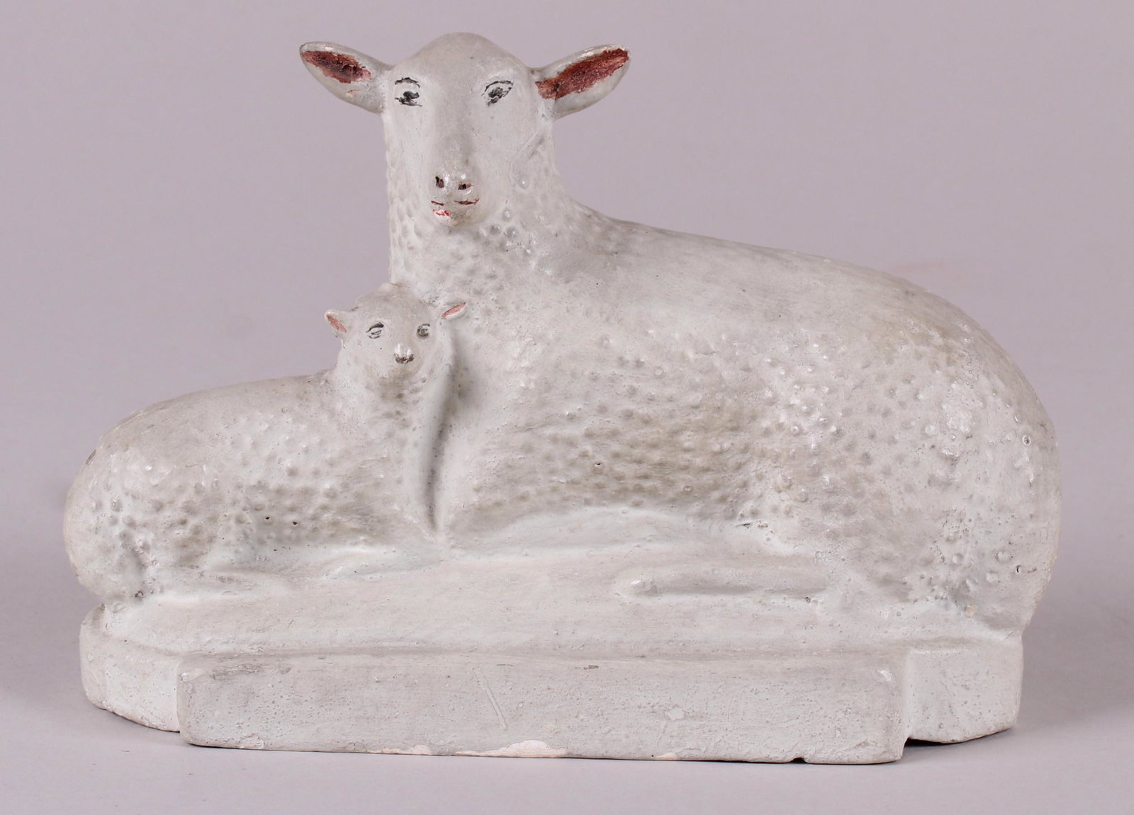 A Chalk Lamp Figural Group: A reclining sheep with lamb on an oval base, painted features. Dimensions: 9" x 4", the height is 6 1/2". Provenance: From a local collection.
