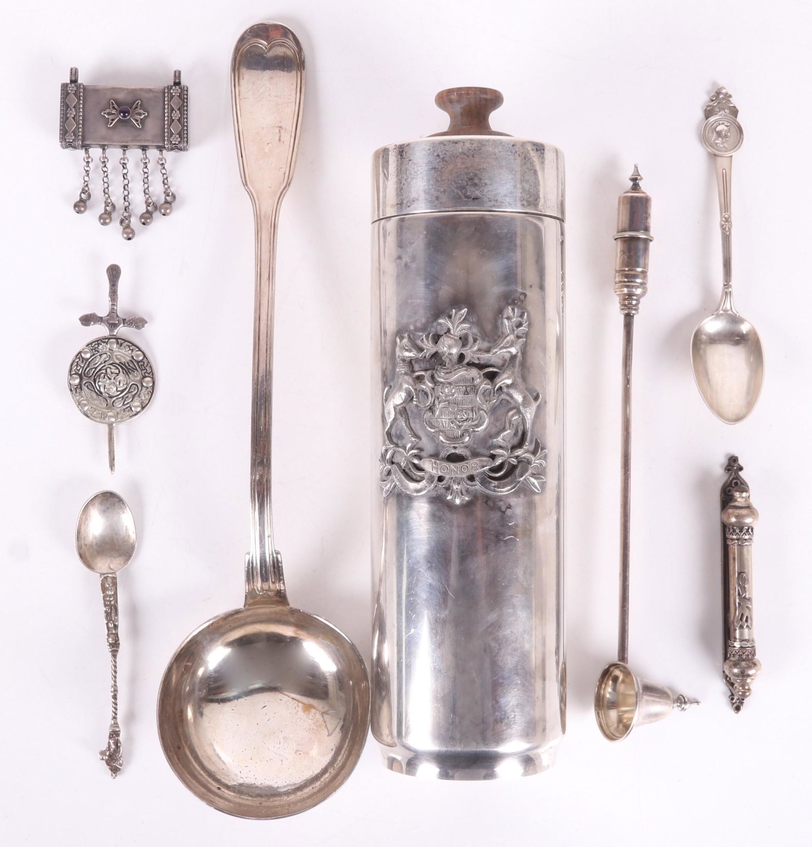 An Group of International Silver Items: Comprising: a large 19th century Continental ladle, a 20th century sterling combination candle snuffer/lighter, a Gorham for Tiffany medallion pattern teaspoon from the late 19th century, a Scottish p