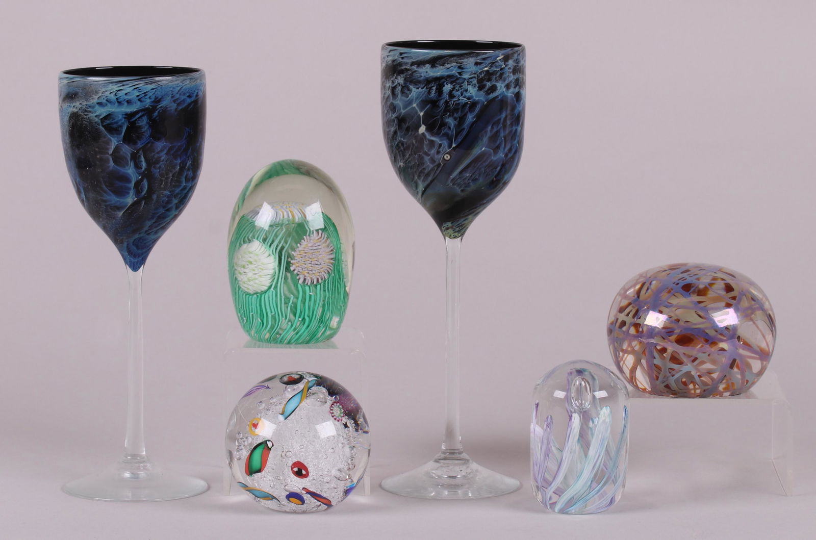Art Glass, Paperweights and Wine Glasses: A pair of signed art glass wine glasses by Josh Simpson and four paperweights, three unsigned and one illegibly signed and dated for 2001. Dimensions: From 2" to 3 1/2" in diameter, the heights range