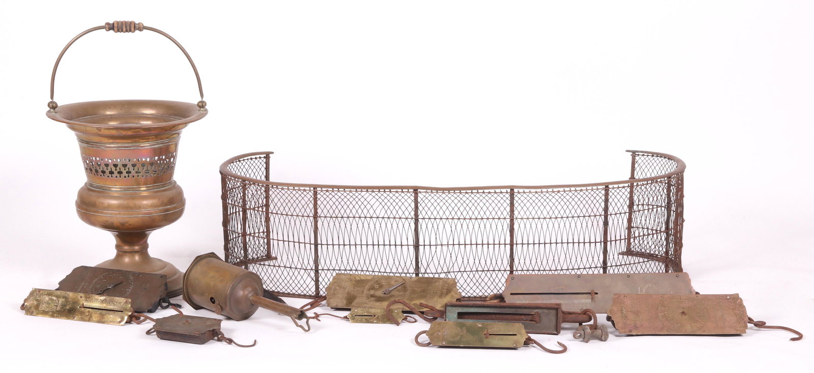 Brass Fireplace Accessories, Hanging Scales: All 19th or early 20th century, comprising: a brass and iron wire fireplace fender, a coal bucket with bail handle, a mechanical spit marked for Chinner and Co. Dudley, and ten hanging scales, marked