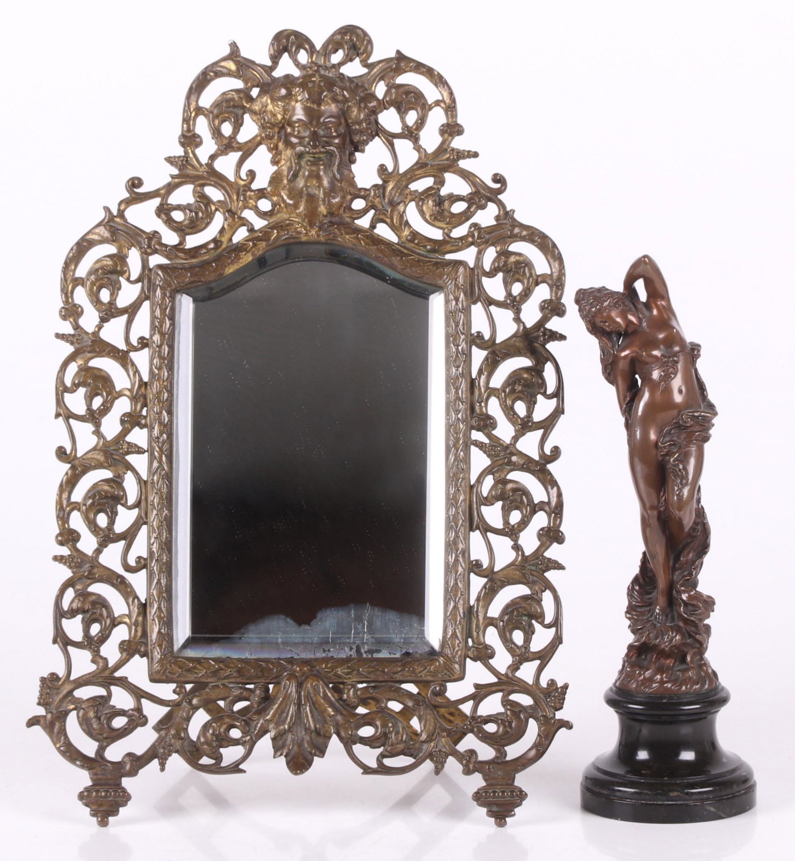 Paul Aichele (1859 - 1910) Bronze: A bronze nude on a marble plinth, signed and dated for 1891, together with a gilt bronze mirror with Bacchus mask decoration, likely by Bradley and Hubbard. Dimensions: The nude is 3 1/2" in diameter 