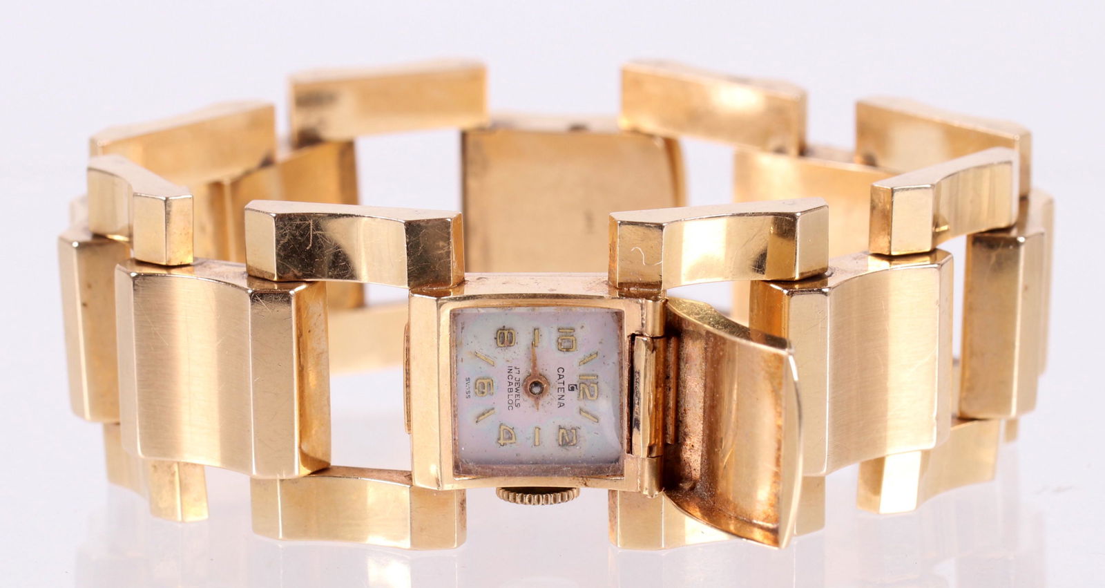 A Mid Century 14k Gold Ladies Watch: The dial of the watch marked for Catena, the 14k gold band with chunky and curved links. Dimensions: The length is 8", the total approximate weight is 30.3 dwt. Provenance: From a local collection.