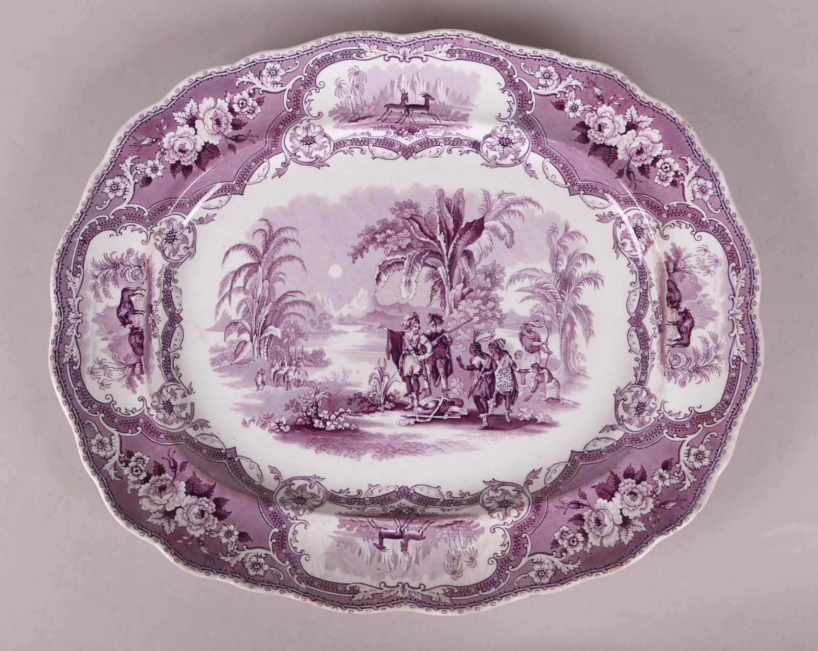 A Large Transferware Platter, Adams: A mulberry transfer platter with a scalloped edge in the Columbus pattern. Dimensions: 19 1/2" x 16". Provenance: From a local collection.