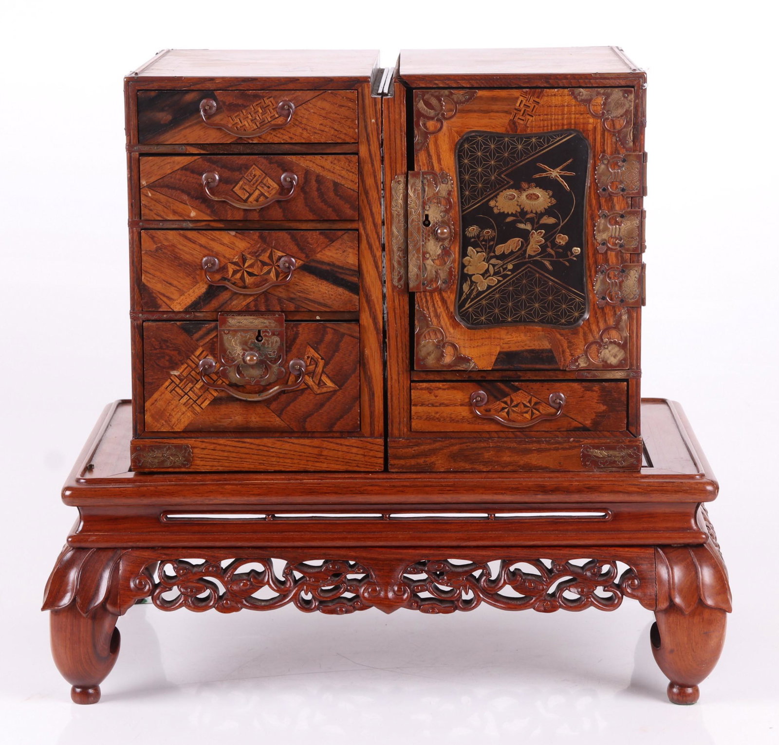 A Pair of Small Japanese Cabinets: Early 20th century, both with elaborate inlaid decoration and an associated Chinese rosewood stand. Dimensions: Each cabinet is 7" x 10" and 11" tall. The stand is 12" x 18" and 6 3/4" tall. Provenanc