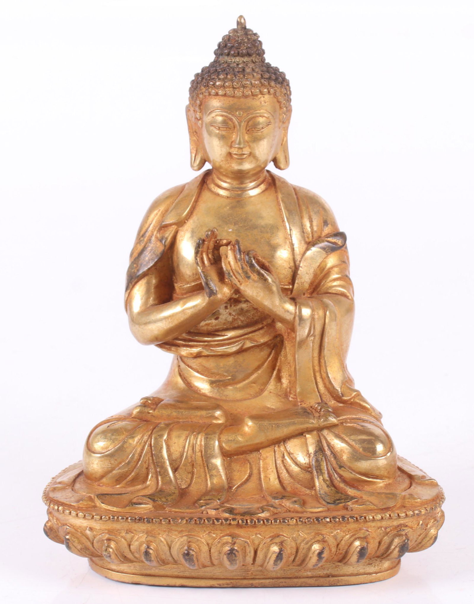 A Gilt Bronze Buddha: 20th century, of typical form and seated on a lotus base. Dimensions: 6" x 5", the height is 8 1/2".