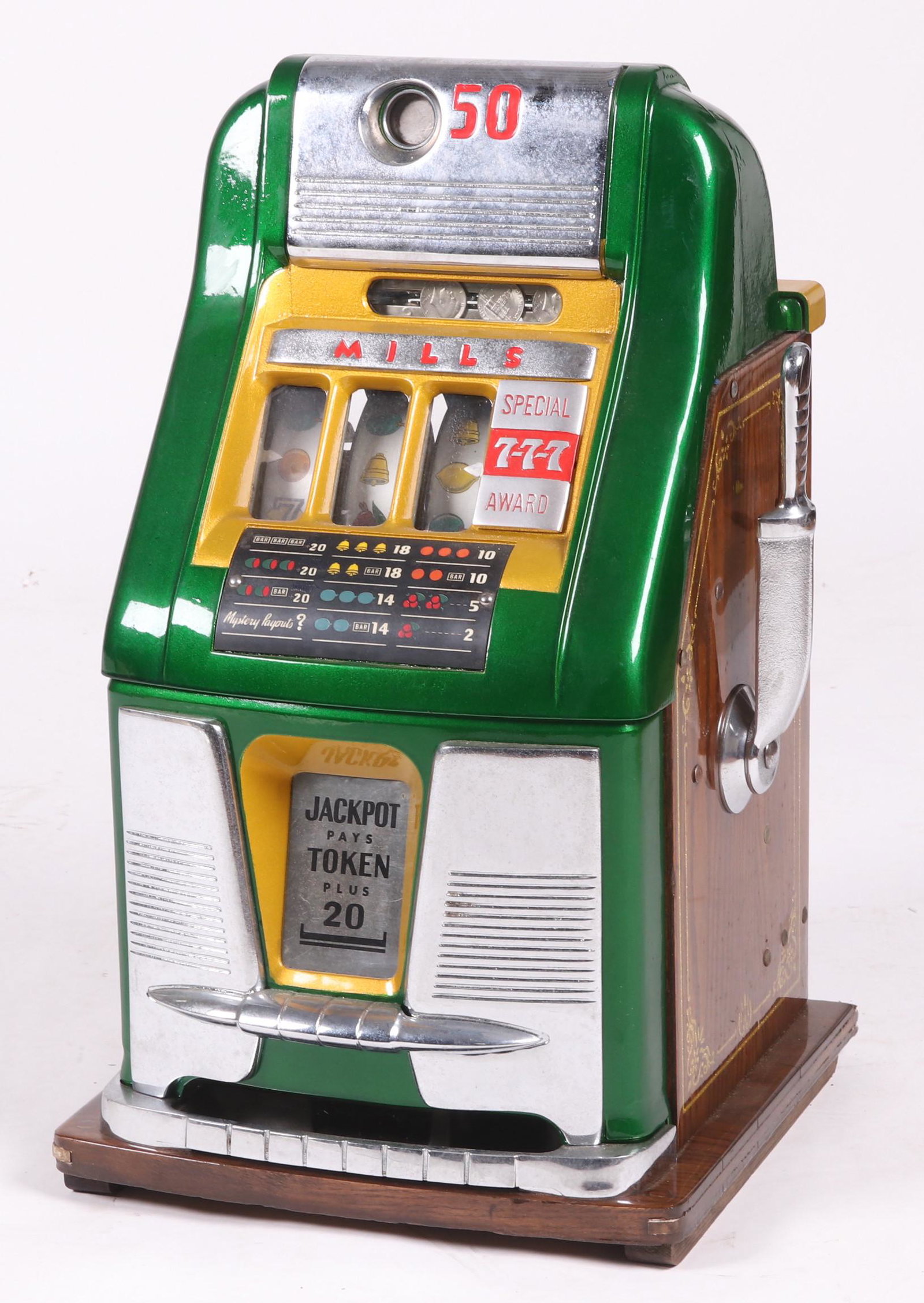 A Mills 50 Cent Slot Machine: "Special Award" in green and chrome, first half of the 20th century. Dimensions: 16" x 15", the height is 24". Provenance: From a local estate.