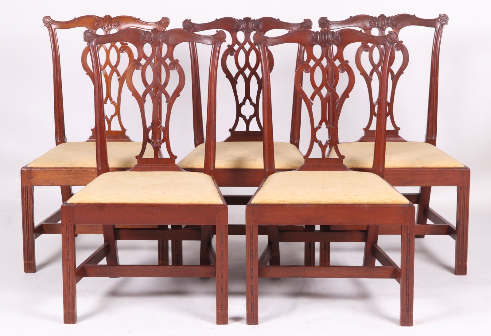 A Set of Five Chippendale Style Dining Chairs: A benchmade set faithfully made in the Philadelphia style and construction. Including mortised through seat rails, pinned construction, and Gothic pierced splats. One chair marked "MADE BY ROBERT B HA