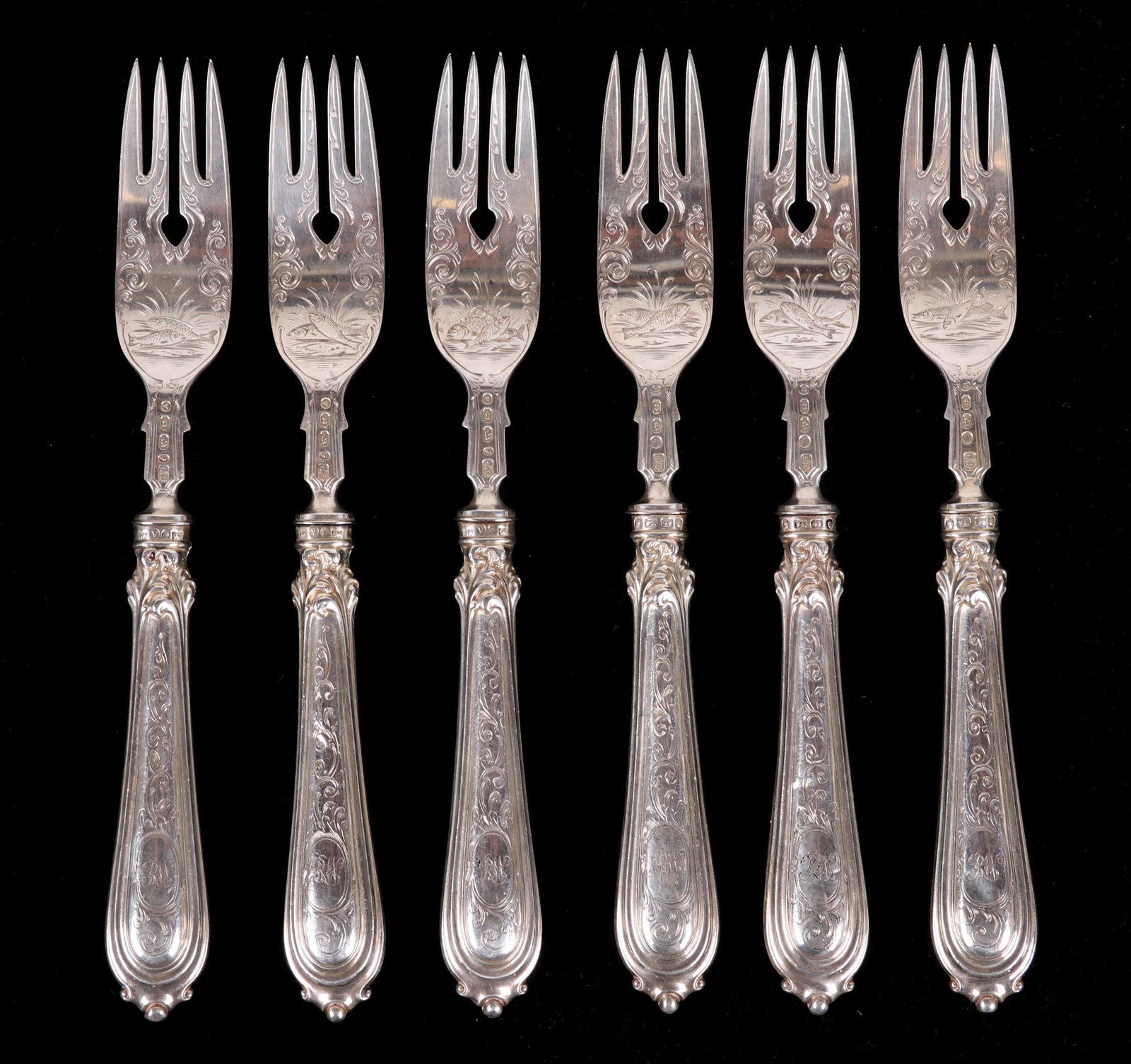 A Set of Sterling Fish Forks, Birmingham 1870: A set of six engraved sterling fish forks hallmarked for Birmingham, the year 1870 and the Maker John Gilbert and Company. The handles are loaded. Dimensions: Each is 7" long. The total approximate gr