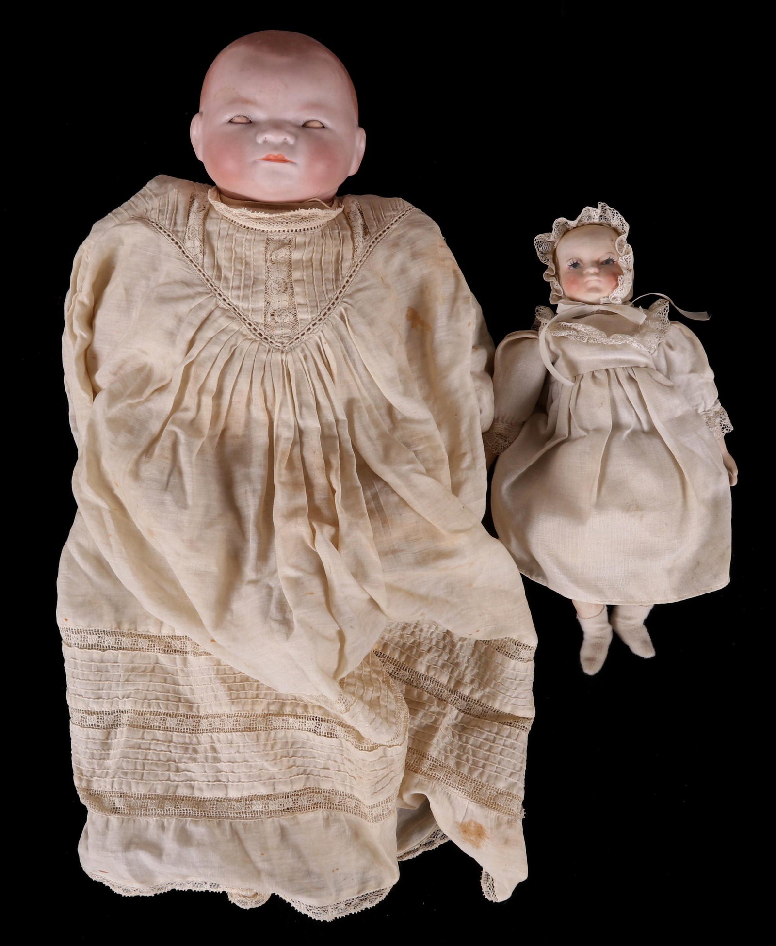 Two Bisque Head Dolls: A 1923 example by Grace Storey Putnam and a small unmarked example with bisque head and limbs. Dimensions: 10" and 15" long. Provenance: From a local collection.
