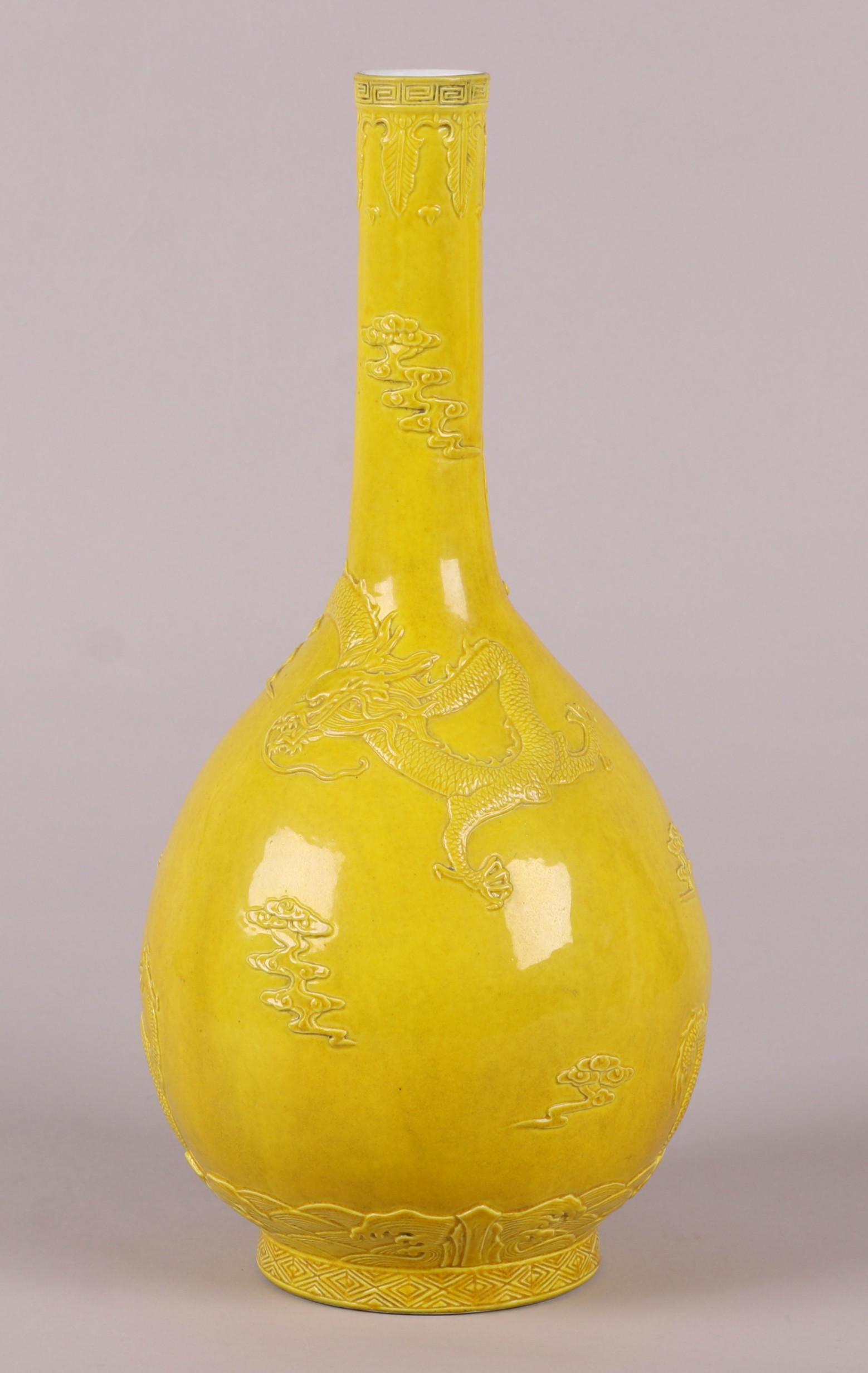 A Chinese Monochrome Porcelain Vase: A yellow bottle form example with low relief dragon and cloud decoration, Daoguang mark but later. Dimensions: 7 3/4" in diameter, 15 1/4" tall. Provenance: From a Main Line Collection.