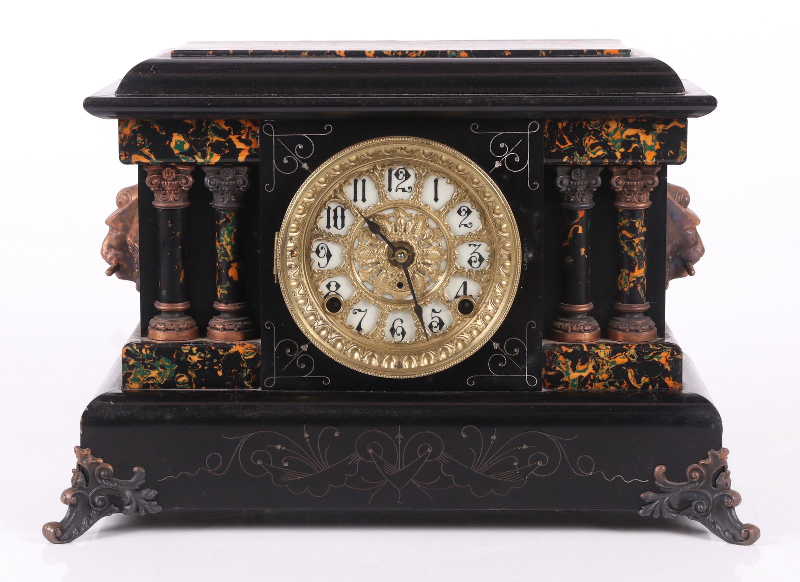 A Seth Thomas Mantel Clock: Early 20th century, with a lacquer and faux marble case and applied metal feet and mask "handles". Dimensions: 15" x 7 1/4", the height is 11 1/4". Provenance: From a Main Line Collection.