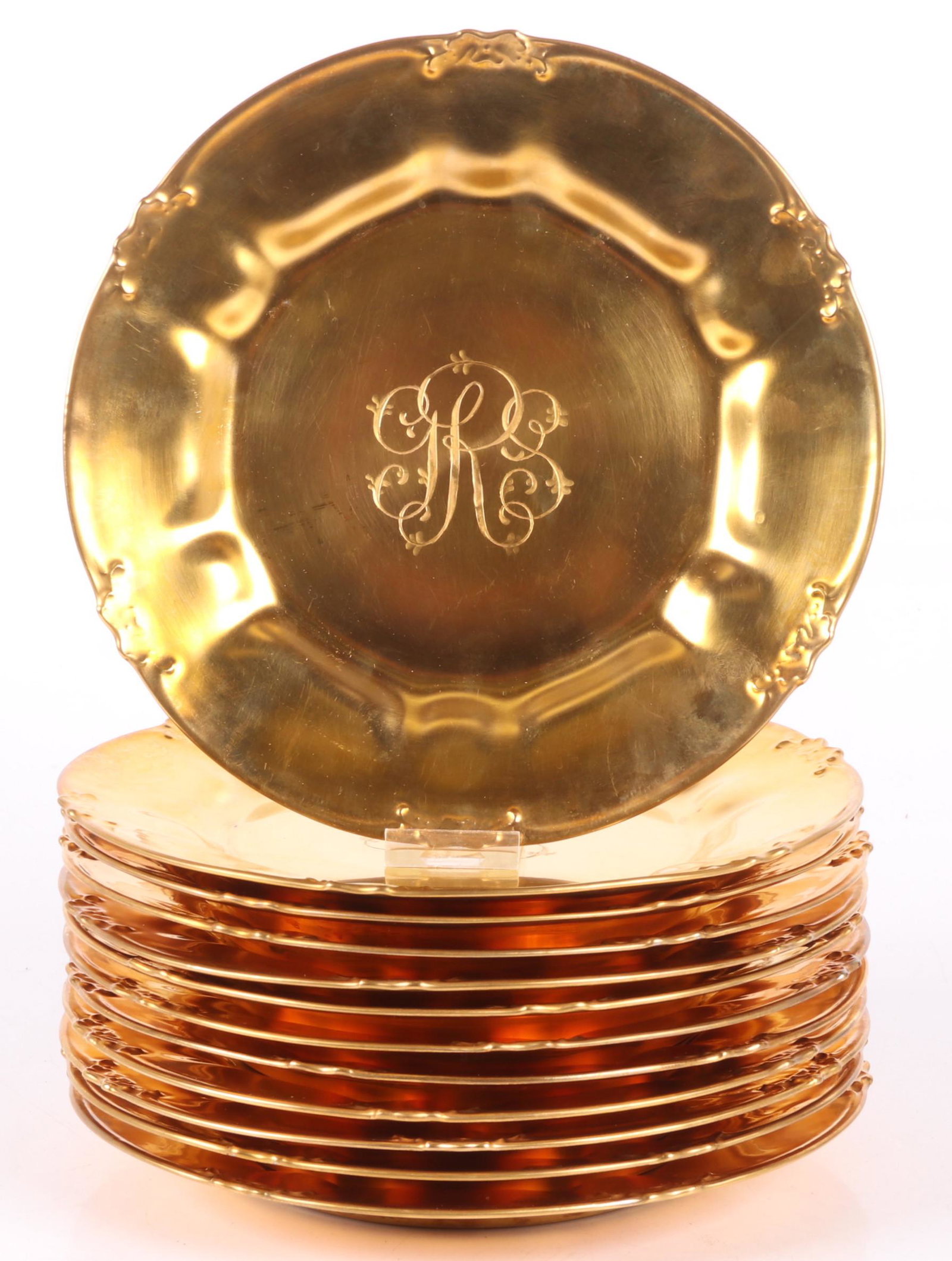 A Set of 12 Gilt Limoges Service Plates: Late 19th or early 20th century, each with a lobed and foliate decorated rim and central monogram. Marked for Gerard, Dufraisseix & Abbot. Dimensions: Each is 9 3/4" in diameter. Provenance: From a Ma
