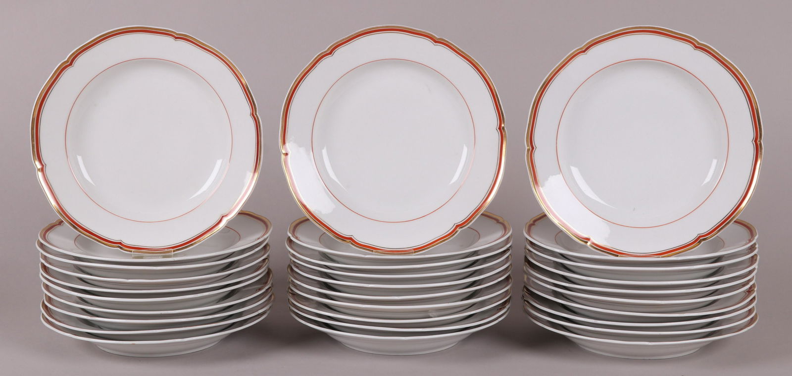 Thirty KPM Porcelain Soup Plates: 19th century, each with a crimson and gilt border. Part of a larger service we are selling in this pattern, please check the other lots in this sale. Dimensions: Each is 9 1/8" in diameter. Provenance