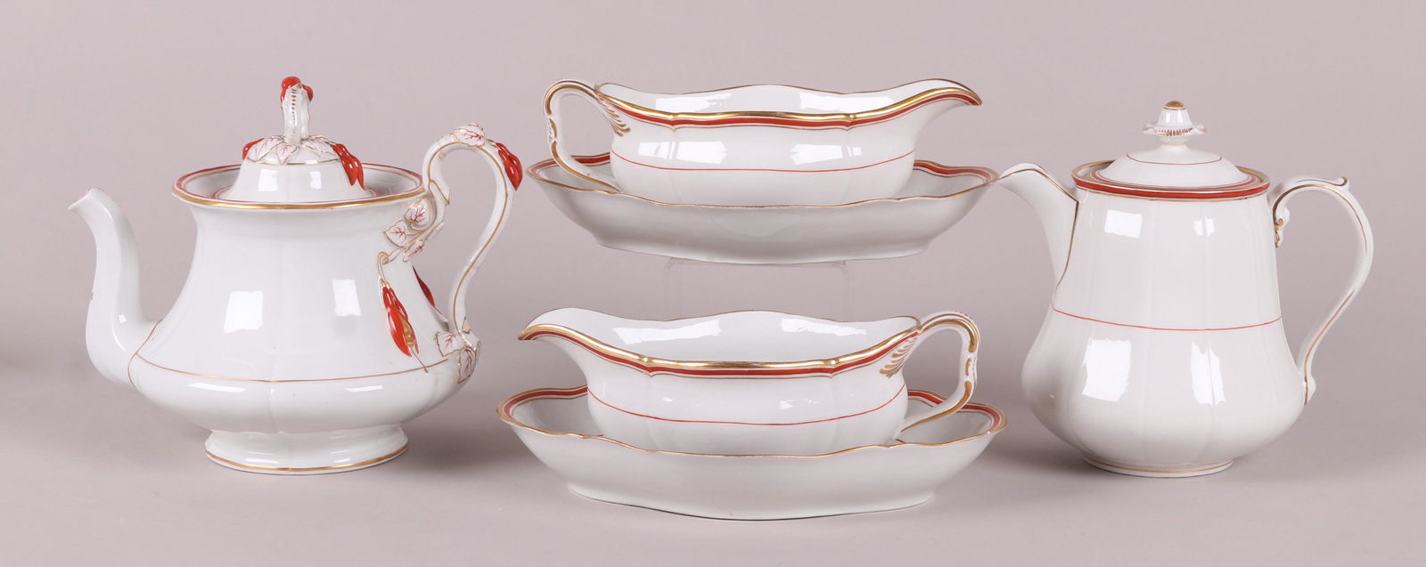 KPM Porcelain, Serving Pieces: 19th century, each with a crimson and gilt border, comprising: A pair of 10 1/2" x 7 1/2" sauceboats with stands, an 8 1/2" cider jug, and a 9" tall teapot. Part of a larger service we are selling in