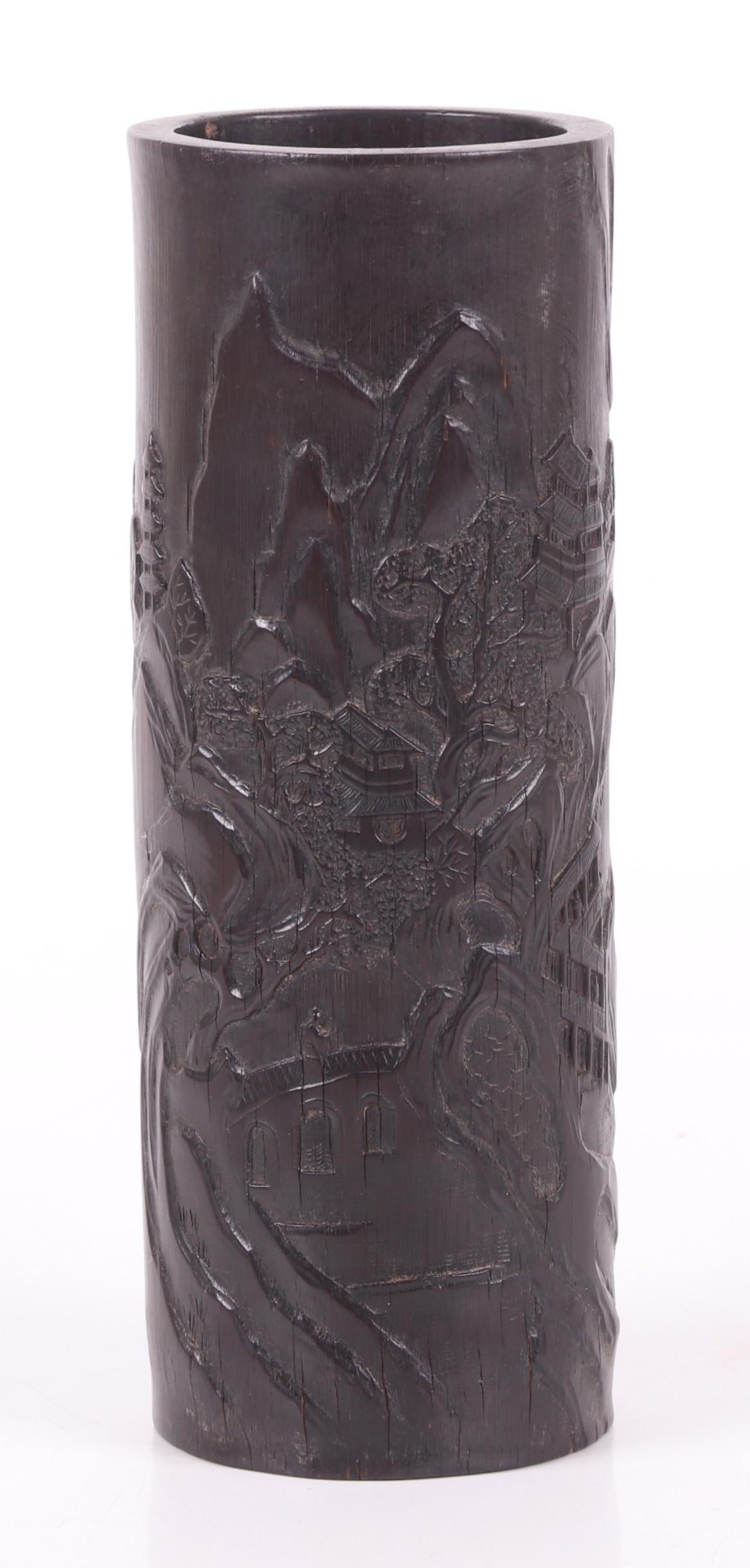A Chinese Bamboo Brush Pot: Qing Dynasty, with good low relief landscape decoration and poetry. Dimensions: 3 1/4" in diameter, 9" tall. Provenance: From a Pittsburgh estate.